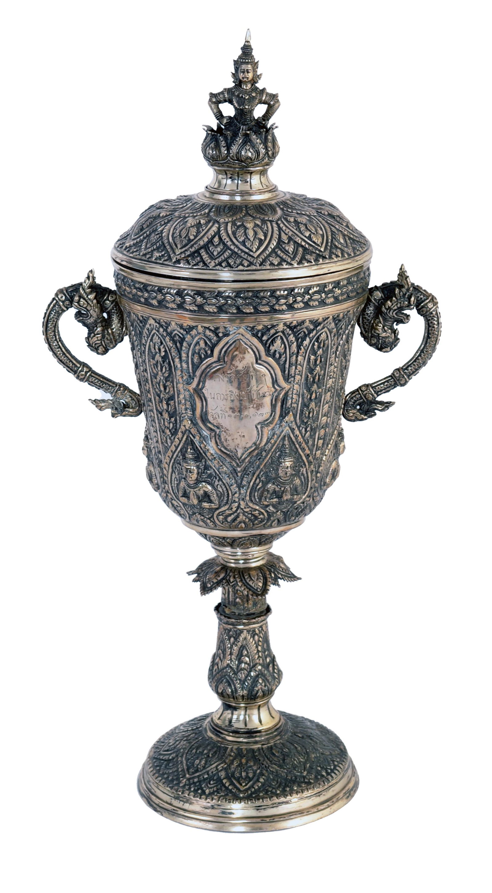 Thai or Burmese Silver Presentation Cup with Lid: Thai or Burmese silver presentation cup with a lid. The cup features 6 figures in the Anjali mudra around the base of the cup surrounded by a floral motif. The cup has 2 beast handles and a central in