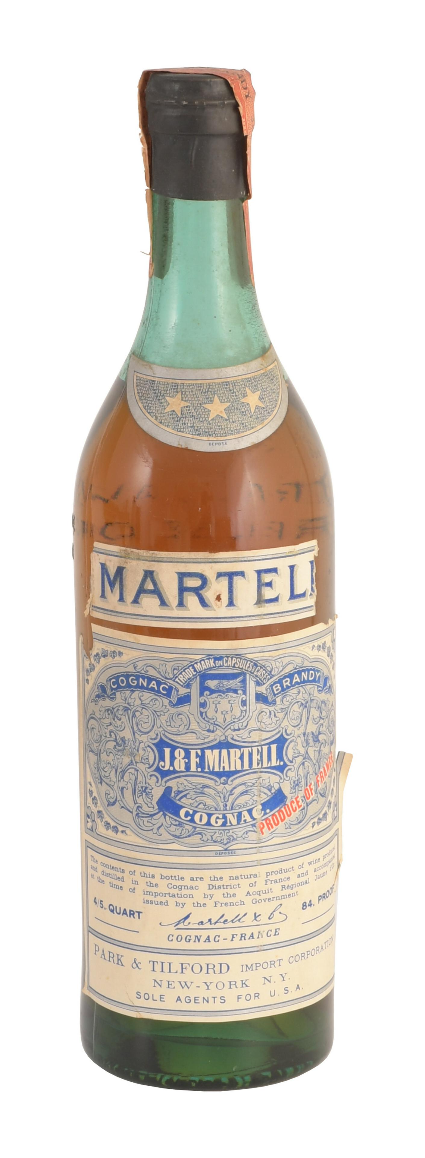 Sealed Bottle Martell 3 Star Cognac C-1950: A sealed bottle of Martell 3 Star Cognac with a series 111 Federal tax stamp. The bottle is 84 proof and 4/5 of a quart. Please note: Due to Virginia’s ABC Law this lot is pickup only, shipping 