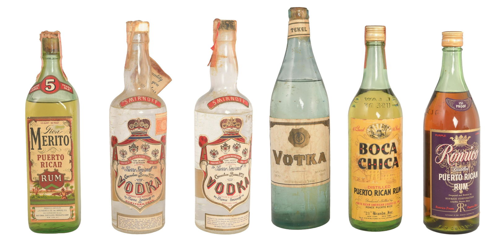 6 Sealed Boca Chica, Ron Merita, Tekel & Smirnoff: The lot includes a bottle of 86 proof Boca Chica Puerto Rican Rum, likely bottled in the early 1950's with series 111 Federal tax stamp and is 4/5 of a quart, a bottle of 5 year old 86 proof Ron Merit