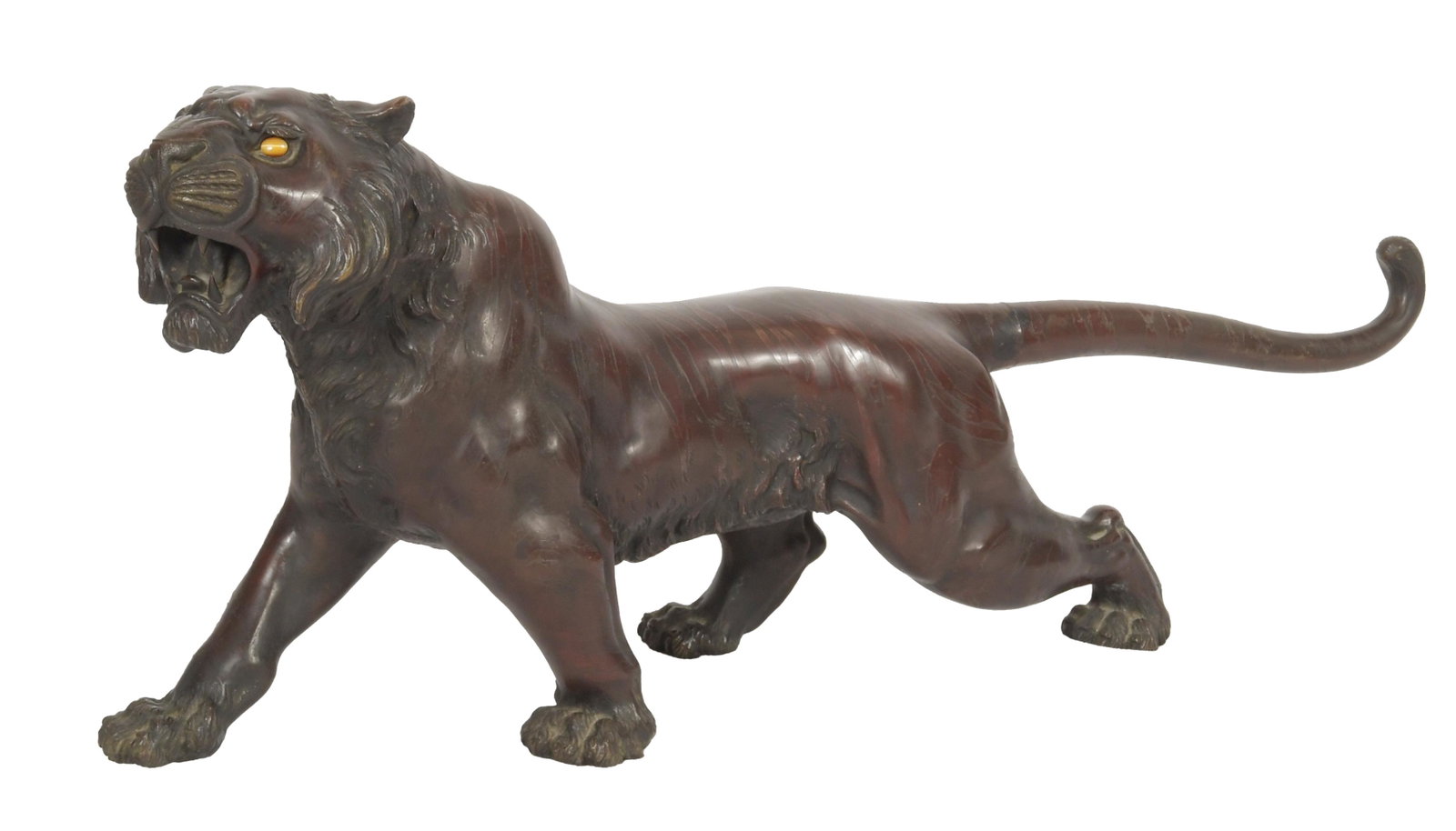 Japanese Bronze Tiger by Jozan, Meiji Period: A Japanese bronze tiger by Jozan and dating to the Meiji Period. The tiger is shown in motion with its feet striding forward and has inlaid stone eyes. The bottom of the statue is signed. Dimensions a
