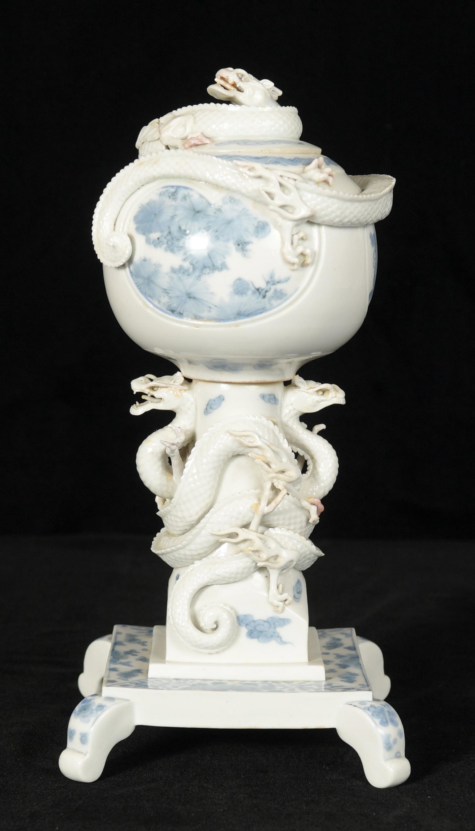 Japanese Hirado Porcelain Koro with Dragons, Meiji: A Japanese Hirado porcelain koro dating to the Meiji period. The koro features two dragons intertwined along the middle section, roudles of blue flowers, and a dragon wrapping around the top onto the 