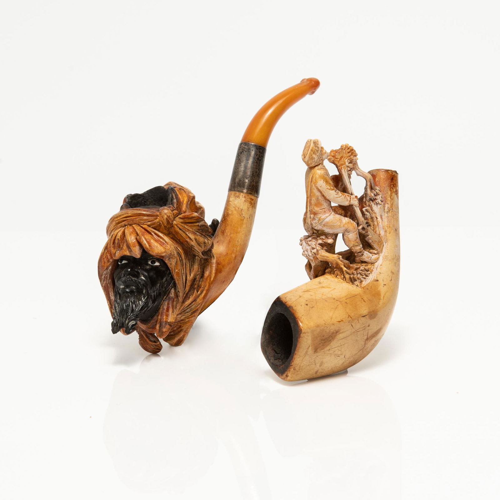 Late 19th/early 20th century meerschaum pipes in leather cases. Arab with separate carved, ebonised (1 of 3)