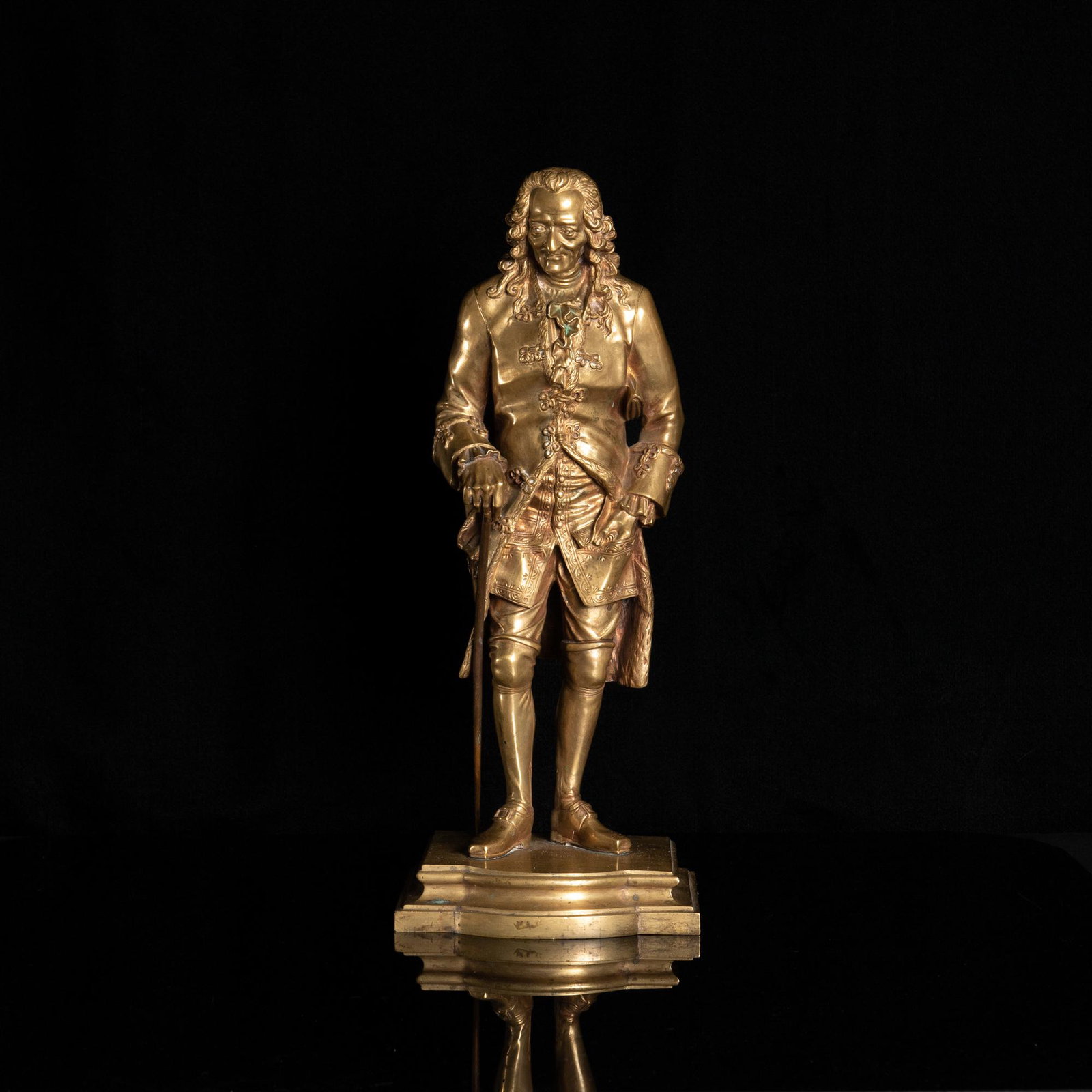 Grand Tour Gilt Bronze of Voltaire after Jean-Claude Rosset: Grand Tour gilt bronze, late 19th century. Unsigned, after Jean-Claude Rosset. Dimensions are: H: 14 3/8 inches, 36.5 cm. W: 5 3/4 inches, 14.6 cm. D: 5 3/4 inches, 14.6 cm. All measurements are appro