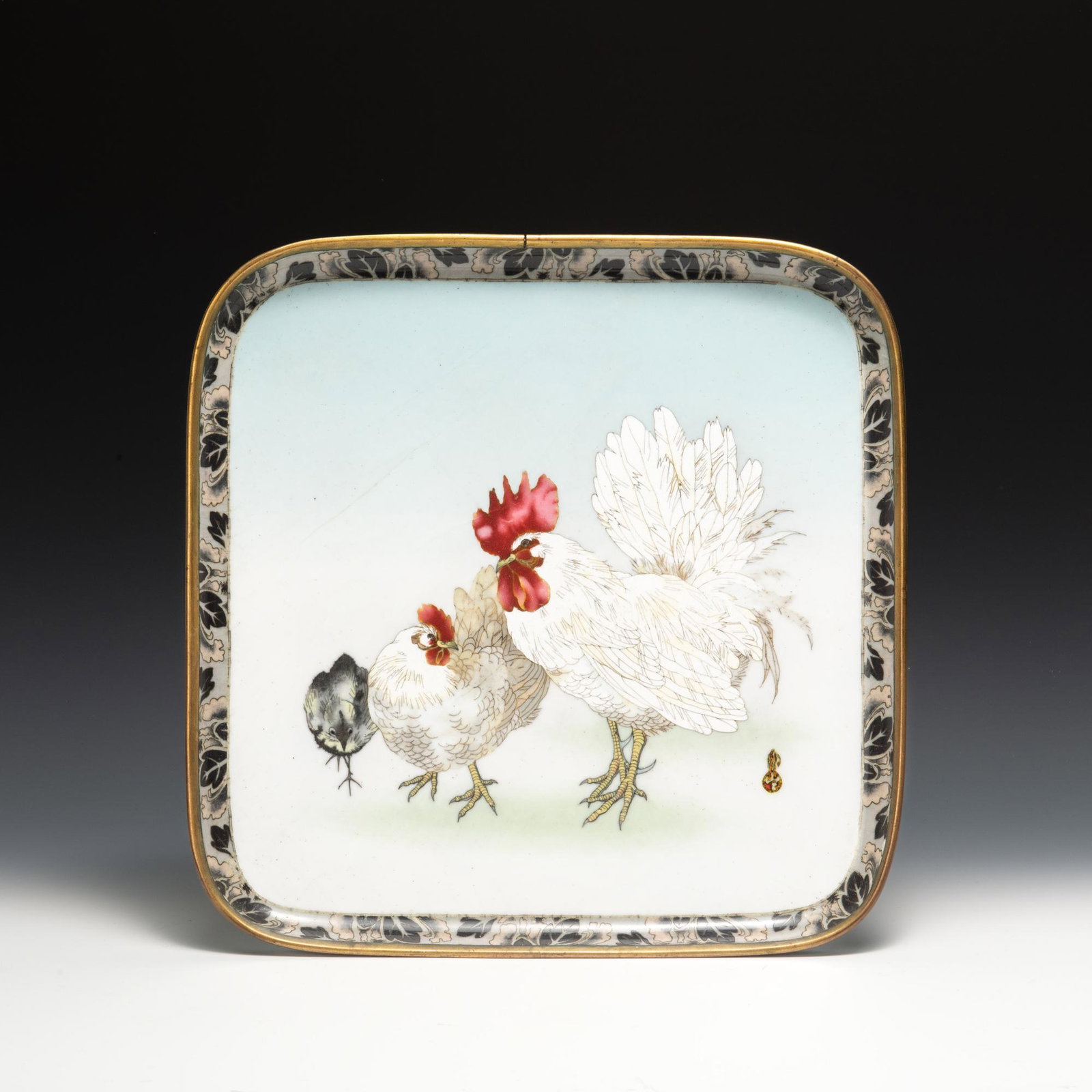 A Japanese cloisonne square tray dating from the Meiji era. The interior depicts 2 roosters while: A Japanese cloisonne square tray dating from the Meiji era. The interior depicts 2 roosters while the bottom depicts flowers with a 6-character mark. Dimensions are: 3/4 inches tall X 11 3/4 inches wi
