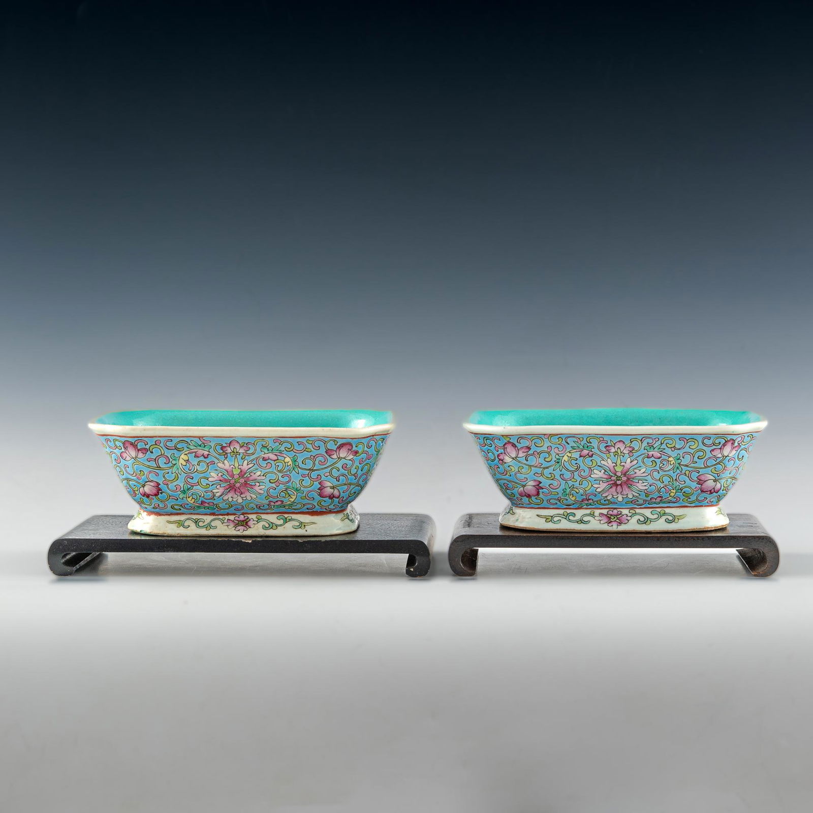 A pair of Chinese blue ground famille rose rectangular footed bowls, each with a 6-character mark on (1 of 6)