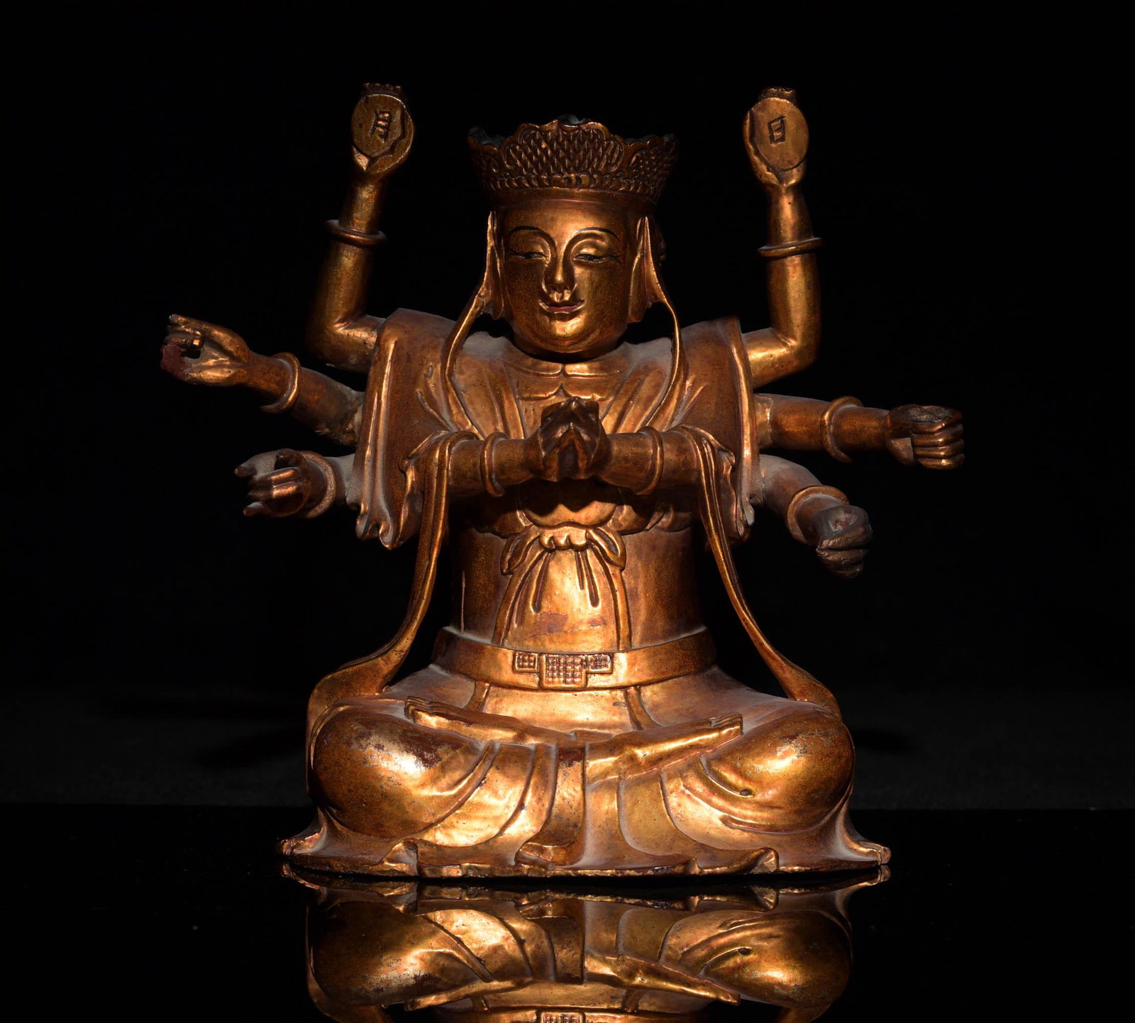 Chinese Gilt Wood Statue of Guanyin, 18-19th Century: A Chinese gilt wood statue of Guanyin dating from the 18th to 19th century. The statue has 4 pairs of arms making mudras and 4 faces. Dimensions are: 6 1/2 inches tall X 6 1/2 inches wide X 3 1/2 inch