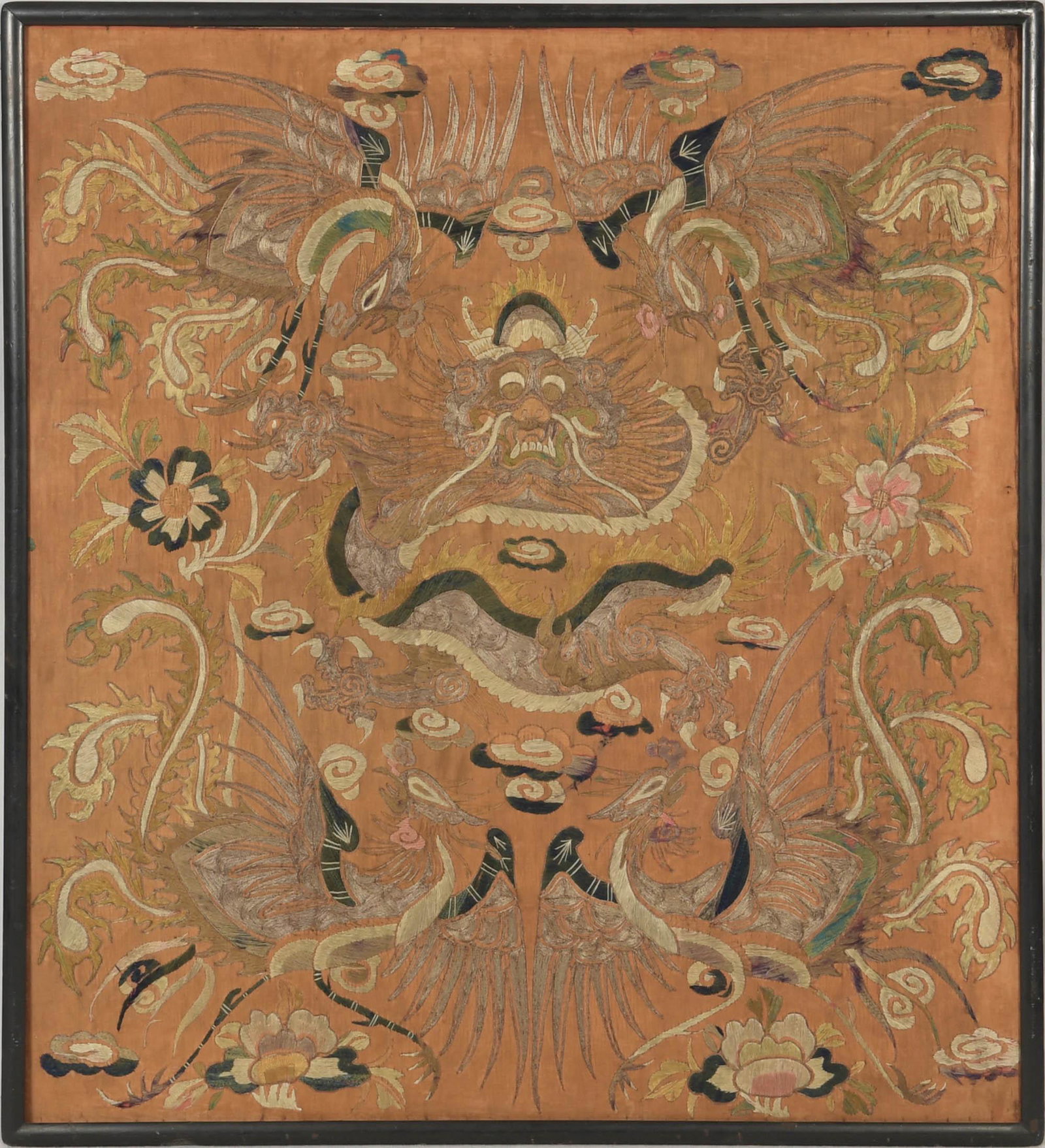 Chinese Embroidery with Dragon and Phoenixes, 19th Century: A Chinese orange ground embroidery dating from the 19th century with a dragon and 4 phoenixes. Dimensions are: 34 1/4 inches tall X 31 1/2 inches wide, 86.99 cm X 80.01 cm, frame measures 35 3/4 inche