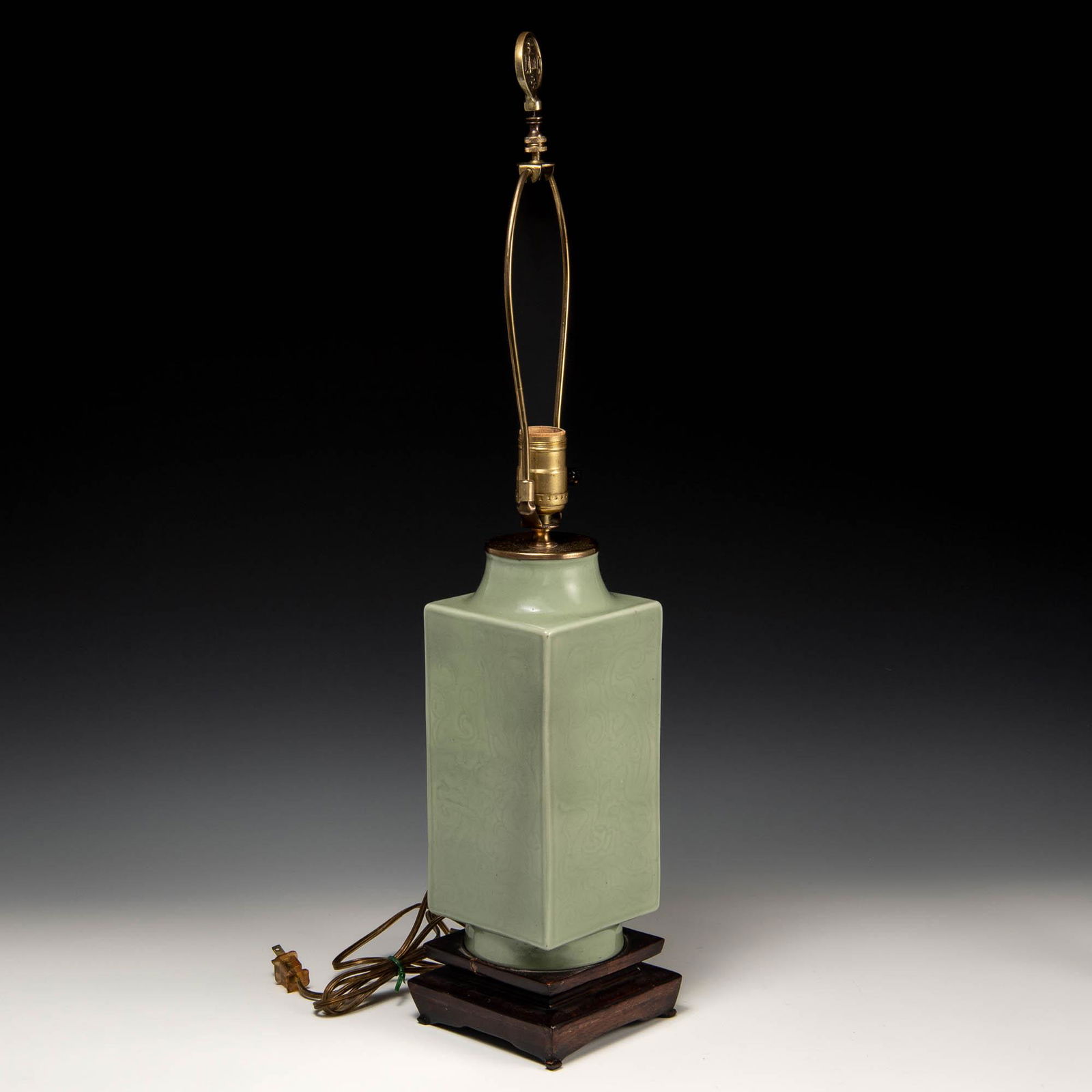 A Chinese celadon incised cong vase, 19th century: A Chinese celadon incised cong vase 19th century Now mounted as a lamp. H: 11, W: 4 1/2, D: 4 1/2 in. (vase) H: 27.94, W: 11.43, D: 11.43 cm. (vase) All measurments are approximate. Provenance: Collec