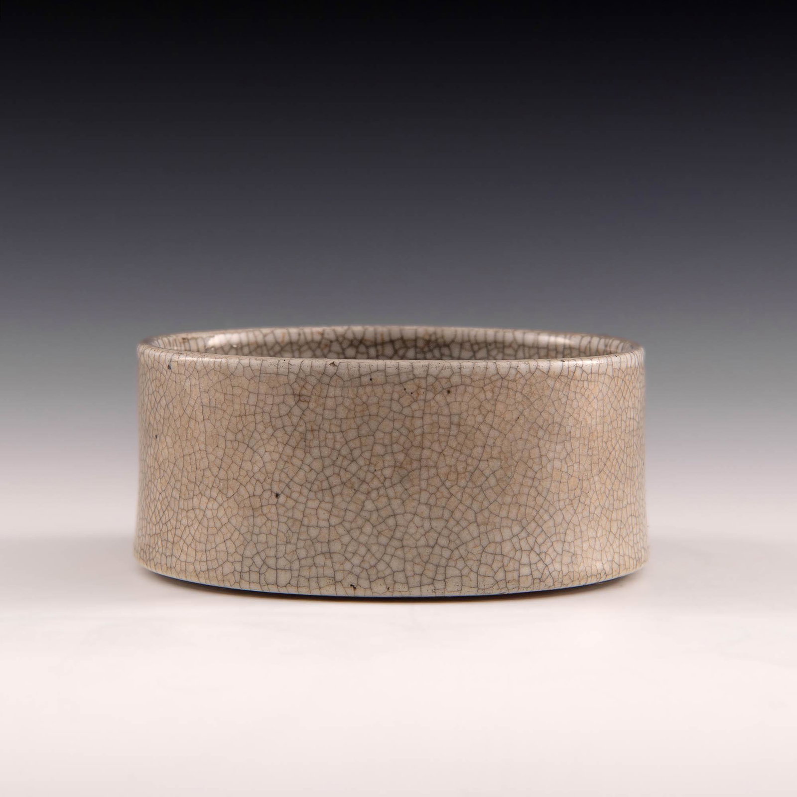 A Chinese ge-glazed brush washer, 18th century: A Chinese ge-glazed brush washer 18th century H: 2 1/4, Dia: 4 3/4 in. H: 5.72 cm, Dia: 12.07 cm. All measurments are approximate. Provenance: Mr. Wong, Honolulu, Hawaii. Acquired in Hong Kong in the 
