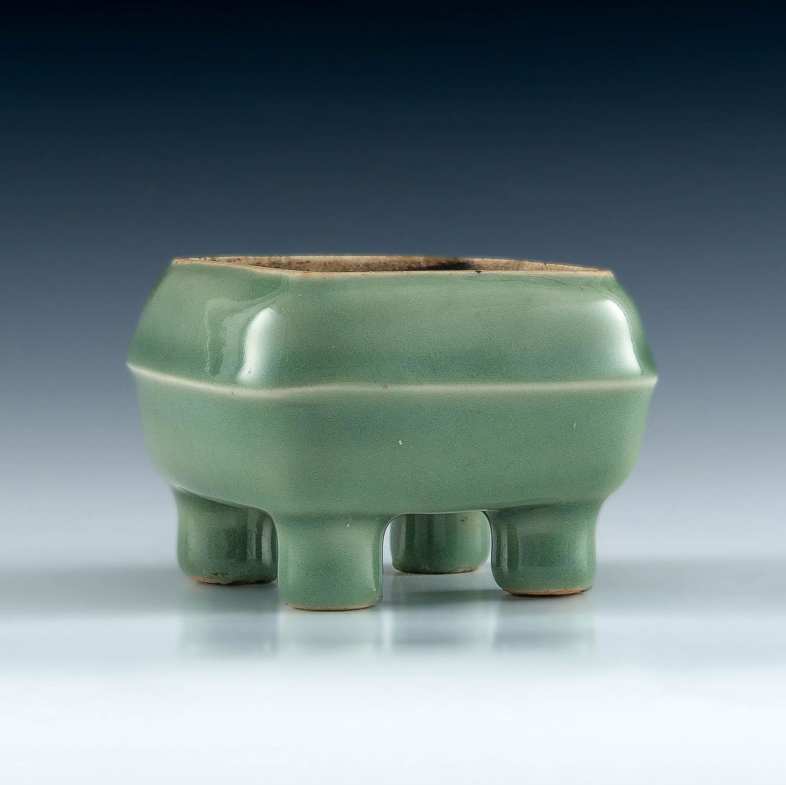 A Chinese celadon ceramic square censer, 18th/19th century: A Chinese celadon ceramic square censer 18th/19th century H: 2 1/4, W: 3, W: 3 in. H: 5.72, W: 7.62, W: 7.62 cm. All measurments are approximate. Provenance: Mr. & Mrs. Ko, New Jersey, collected mostl