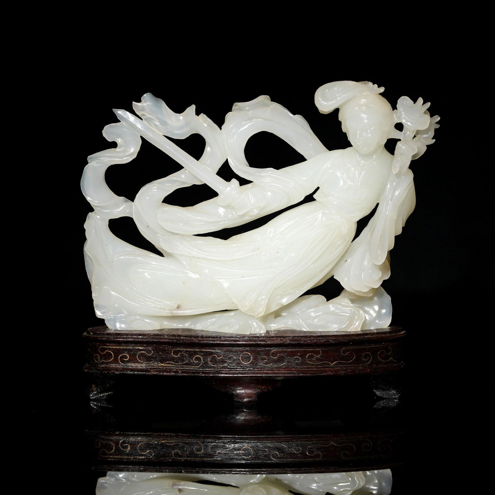 A Chinese white jade carving of a beauty holding a sword and lingzhi with wooden stand, Mid-20th (1 of 6)