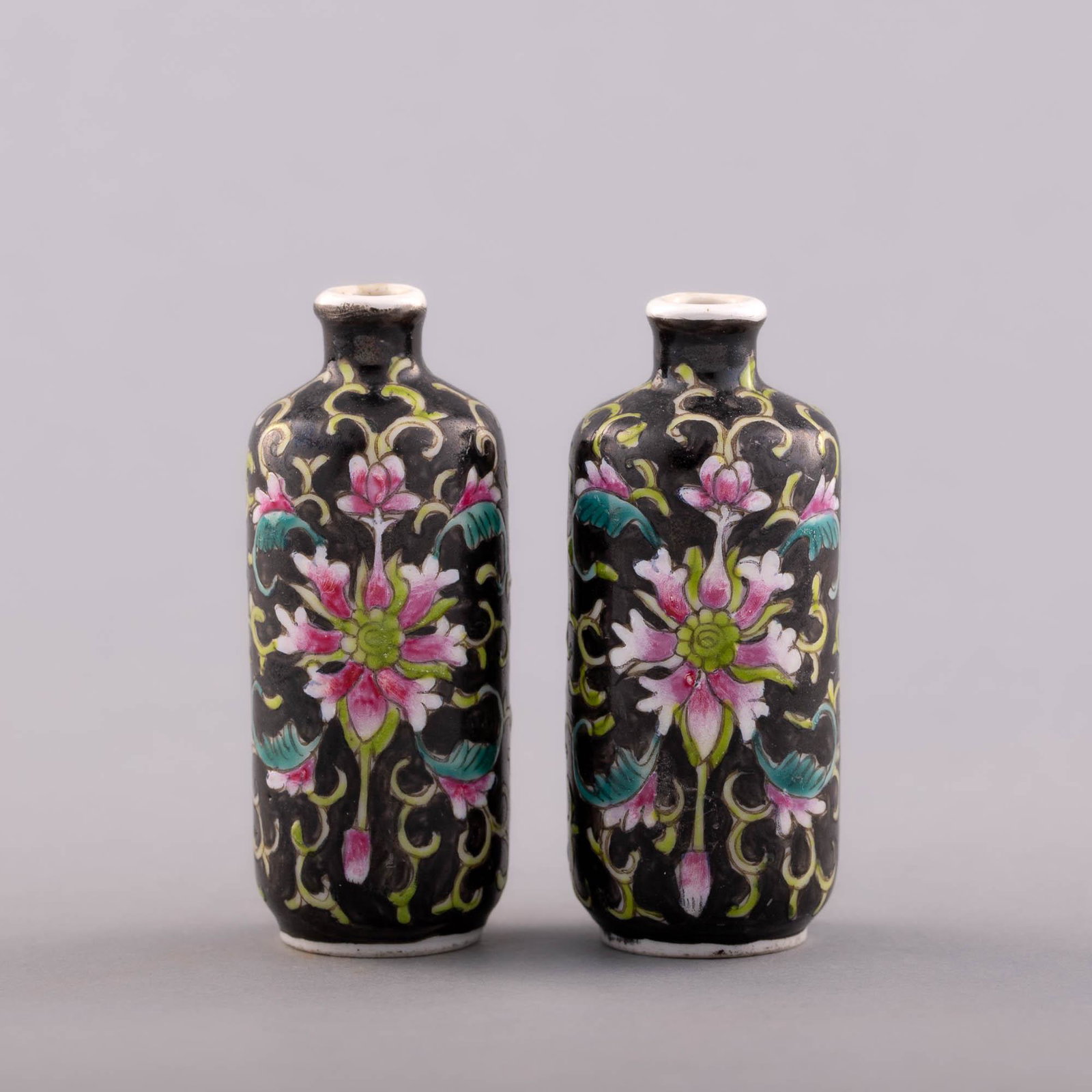 A pair of Chinese famille noire snuff bottles, Republic period: A pair of Chinese famille noire snuff bottles Republic period Each with a four-character mark and previous sticker to underside. H: 2 5/8 in. (H: 6.67 cm.) Provenance: Private collection, Palm Springs