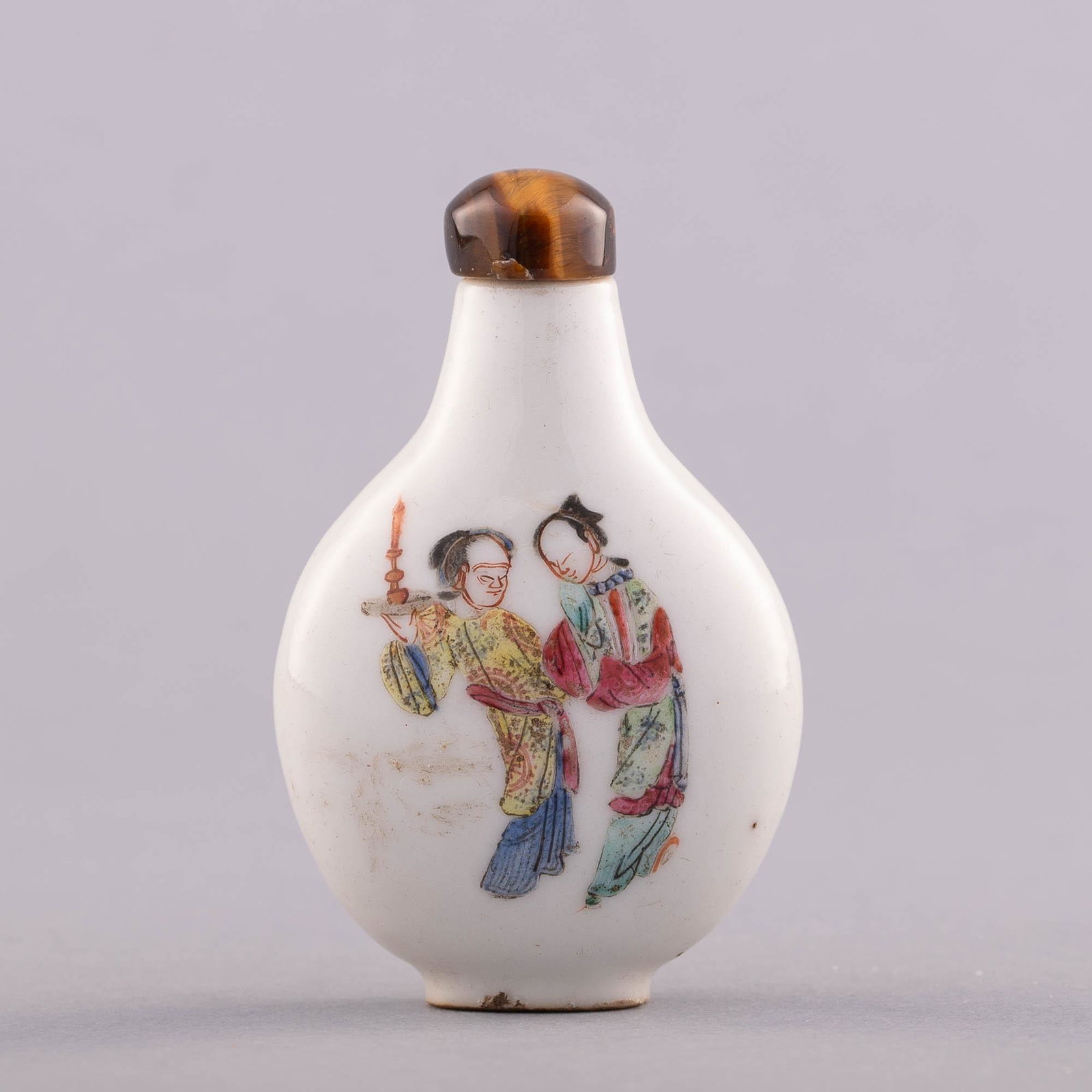 A Chinese famille rose snuff bottle, Daoguang period: A Chinese famille rose snuff bottle Daoguang period Featuring a scholar to one side and two attendants on the other; four-character Daoguang mark to underside. Sold with associated stopper. H: 3 1/8 i