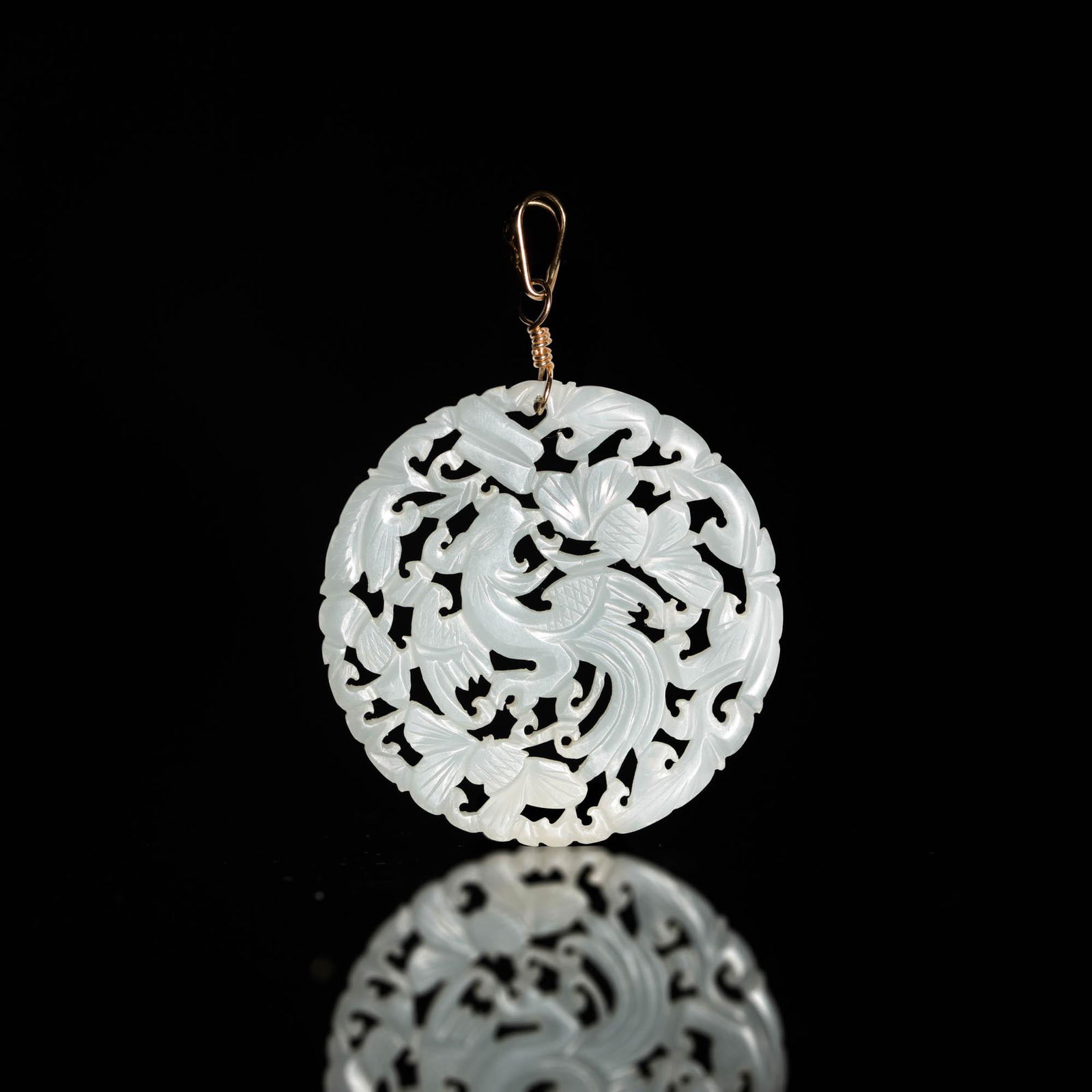 A Chinese white jade pierced carved round plaque, 19th century (1 of 3)