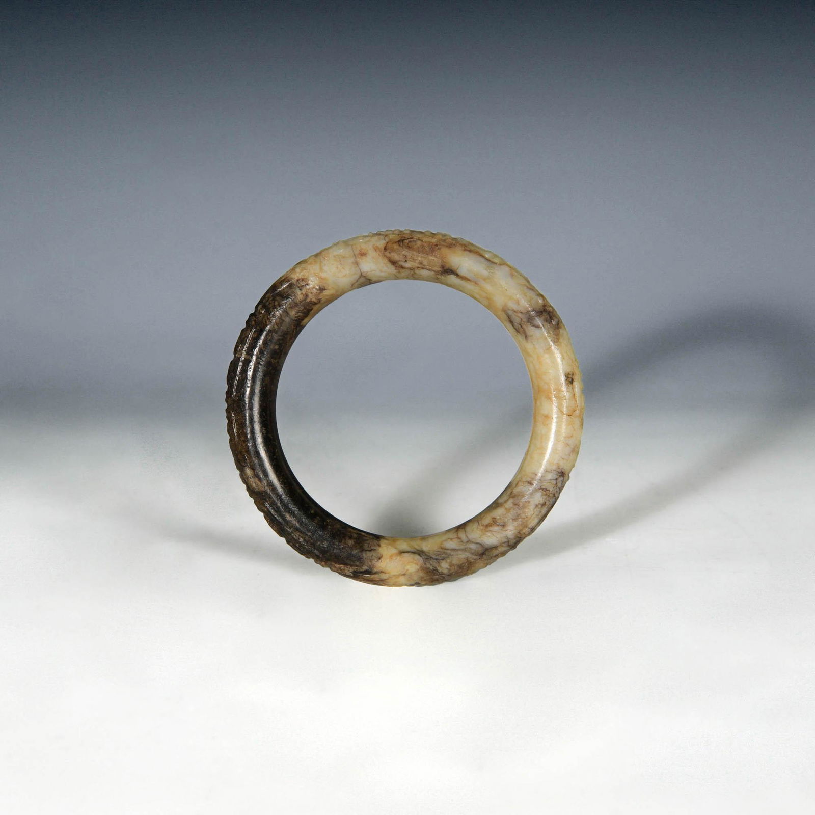 A Chinese jade bangle carved with old characters, Ming dynasty (1 of 3)