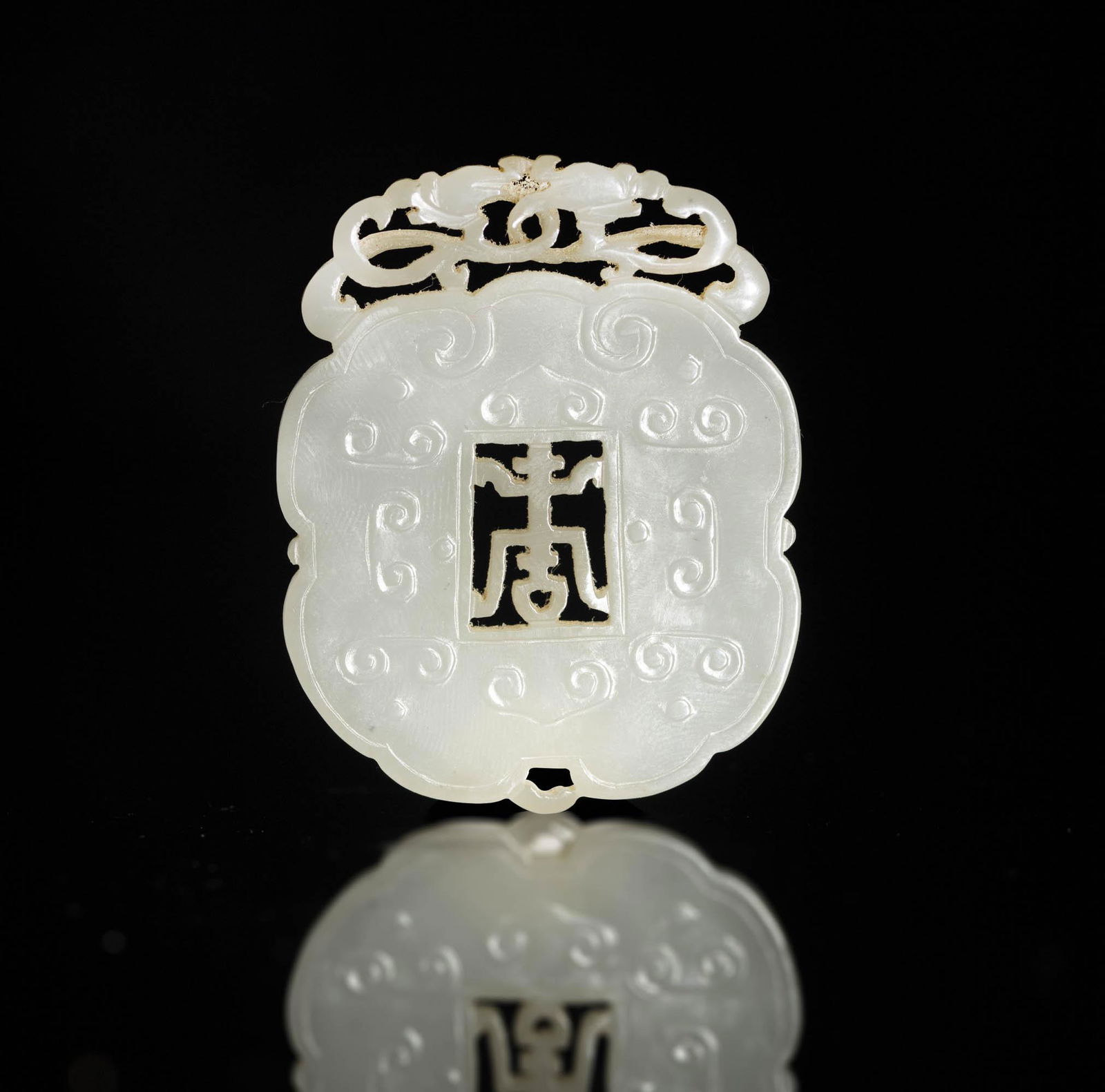 A Chinese white jade plaque carved with a character of longevity, 18th/19th century (1 of 3)