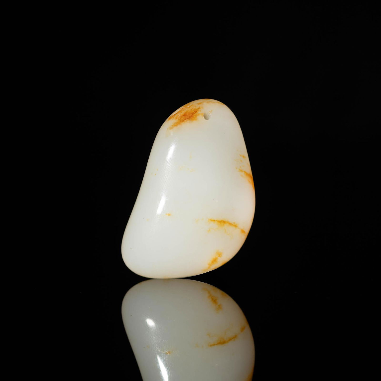 A Chinese white jade pebble made into a toggle, 18th/19th century (1 of 3)