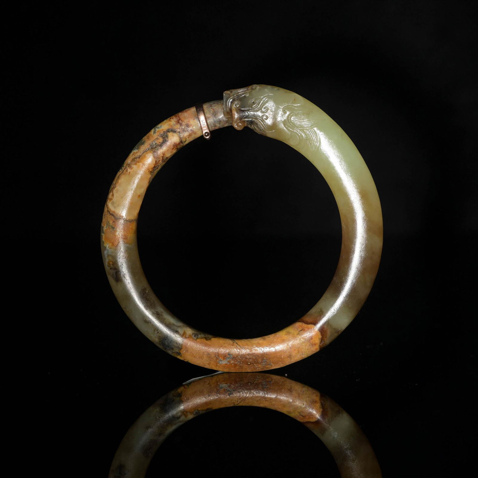 A Chinese jade chilong-form bangle, Ming dynasty or earlier (1 of 3)