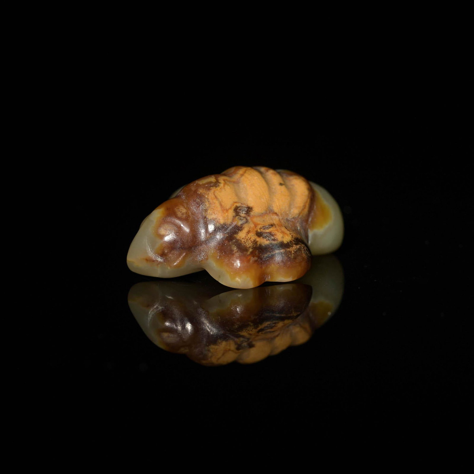 A Chinese jade bird toggle, Ming dynasty or earlier: A Chinese jade bird toggle Ming dynasty or earlier With a drilled hole between the wings. H: 1/2, L: 1 5/8, D: 1 1/4 in. (H: 1.27, W: 4.13, D: 3.18 cm.) Provenance: Mr. Yiu, Boston, Massachusetts. Acq