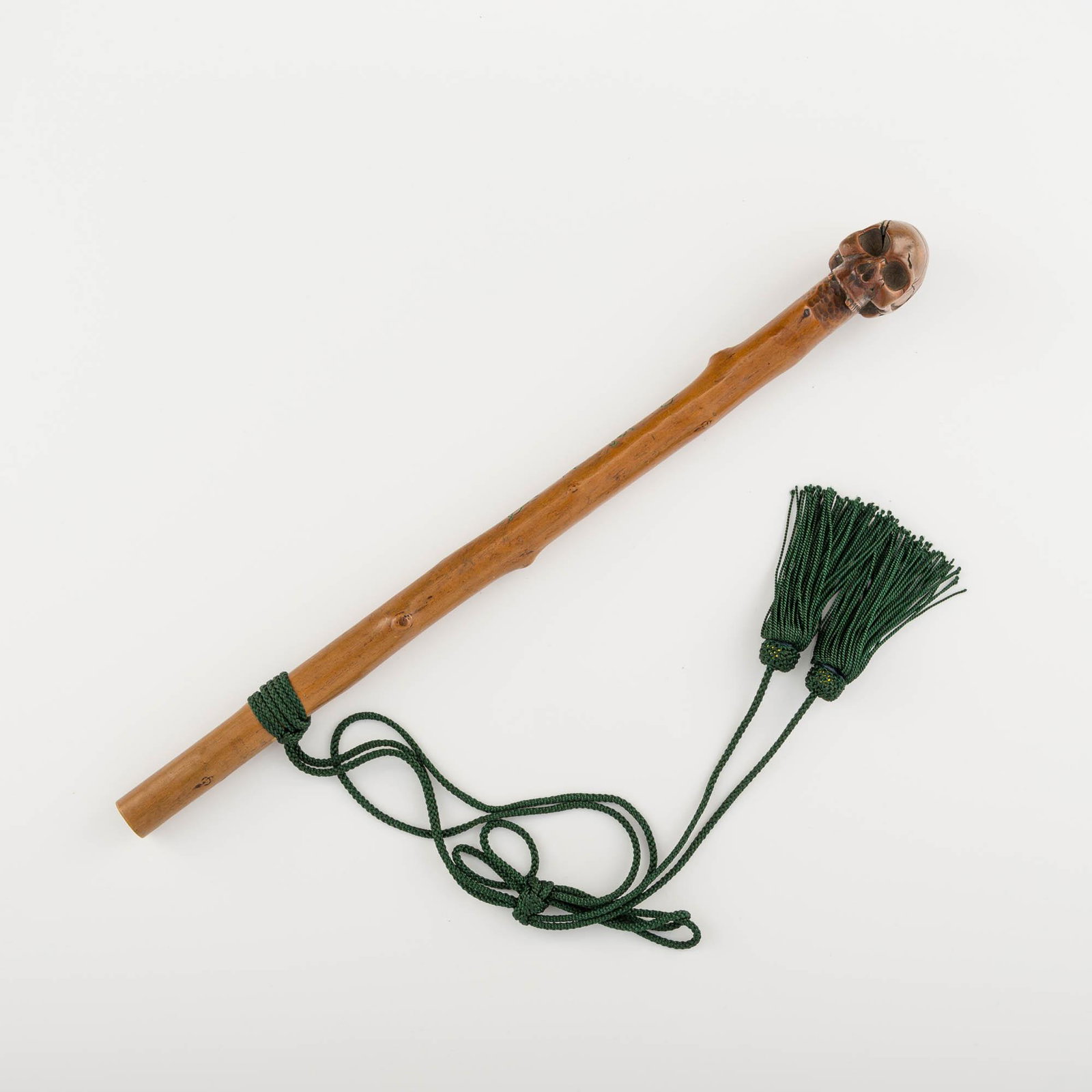 Japanese boxwood skull sceptre, Meiji: A Japanese boxwood skull sceptre Meiji era Signed "Kanryu" (Japanese, 19th century) and inscribed 'inn' and 'hot spring'; with a green tassel attachment. Length: 14 in. (sceptre only) Length: 35.56 cm