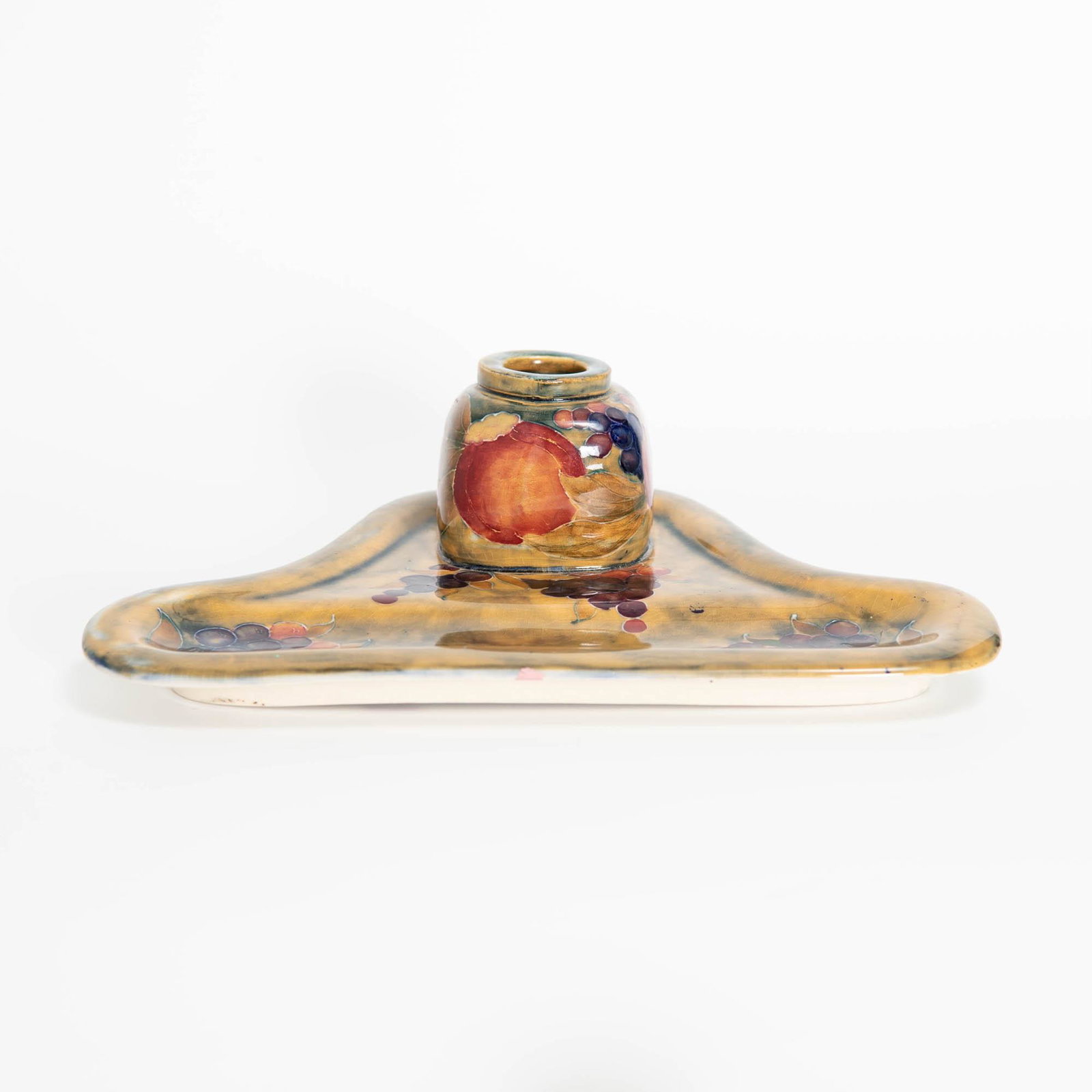 A Moorcroft 'Pomegranate' inkstand, William Moorcroft for Liberty & Co., London, circa 1910: A Moorcroft 'Pomegranate' inkstand William Moorcroft for Liberty & Co., London, circa 1910 Signed and inscribed "Made for Liberty&Co" and "192" to underside. H: 2 5/8, W: 9, D: 5 7/8 in.(H: 6.67, W: 2