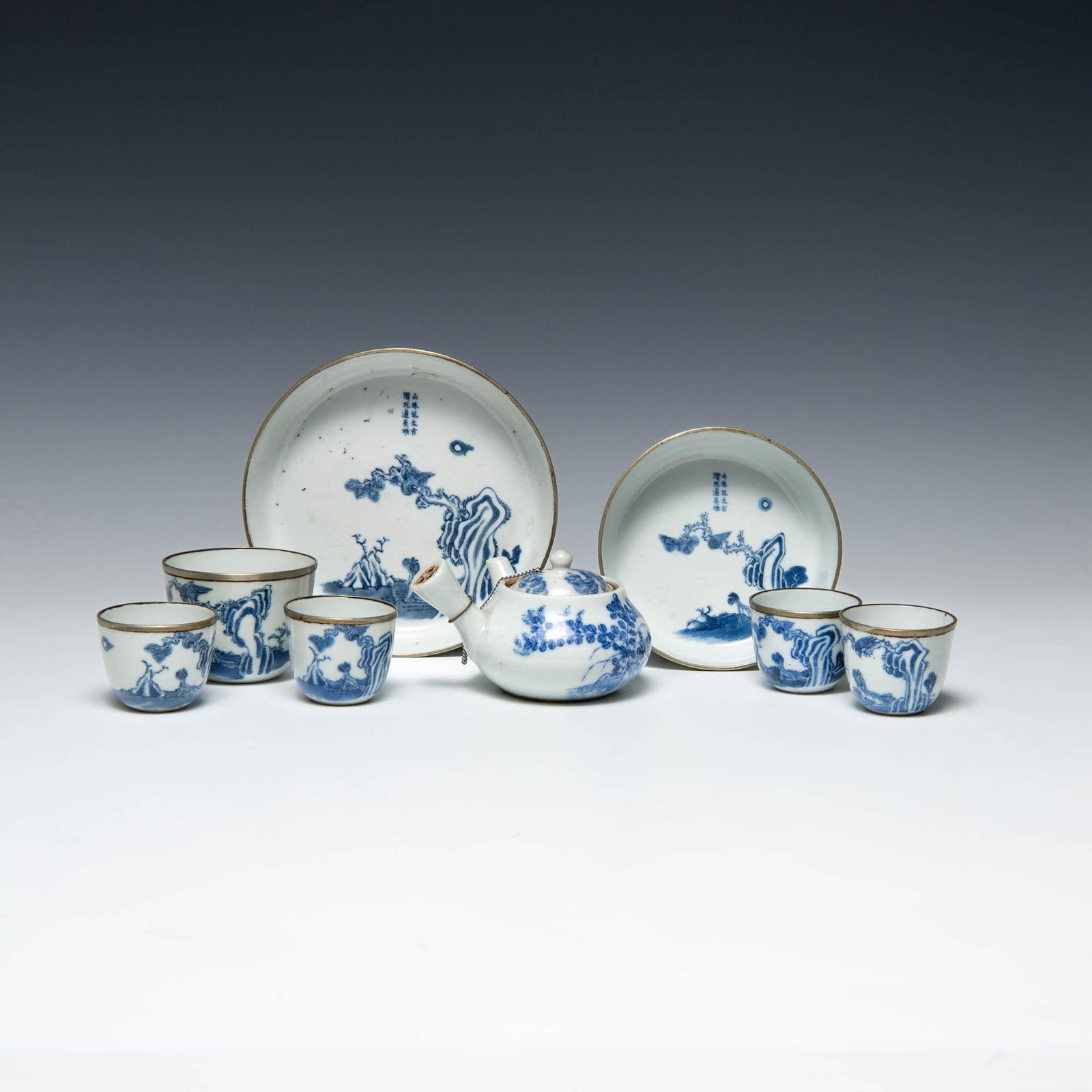 An eight-piece blue and white Vietnamese tea set, late 19th century: An eight-piece blue and white Vietnamese tea set late 19th century Each cup and bowl with two-character mark to underside, teapot with a floral design to the underside. (8). H: 1 1/8, Dia: 5 3/4 in. (
