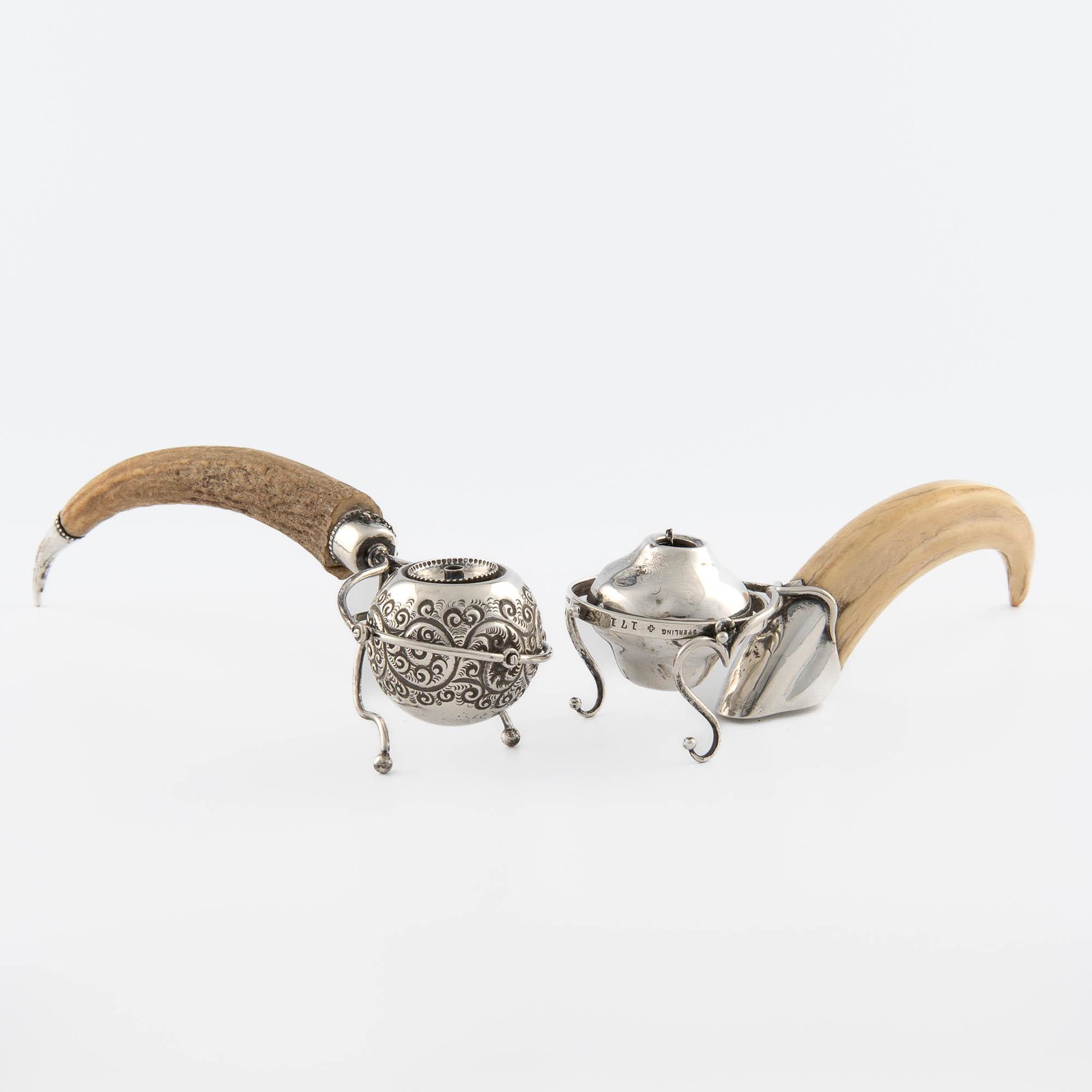 Two sterling silver gimbal-mounted cigar lighters: Two sterling silver gimbal-mounted cigar lighters probably American, late 19th/early 20th century One with boar tusk handle with .825 sterling hallmark, "171", "FINE" marked to gimbal; the other with 