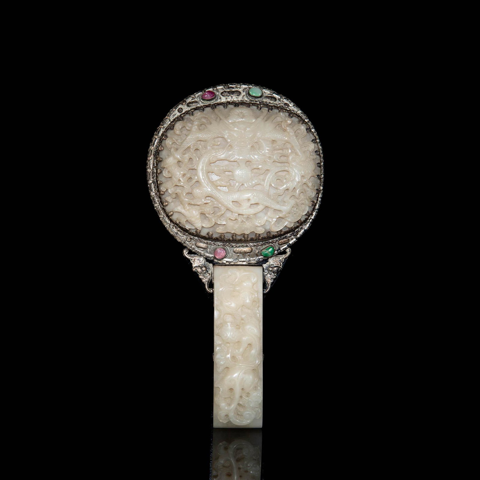 A Chinese silver mirror with inlaid jade, 18th century (jade plaque): A Chinese silver mirror with inlaid jade 18th century (jade plaque) The recto fitted with a silver and jade handle, carved with floral motifs and flanked on either side by bats. The verso with a large