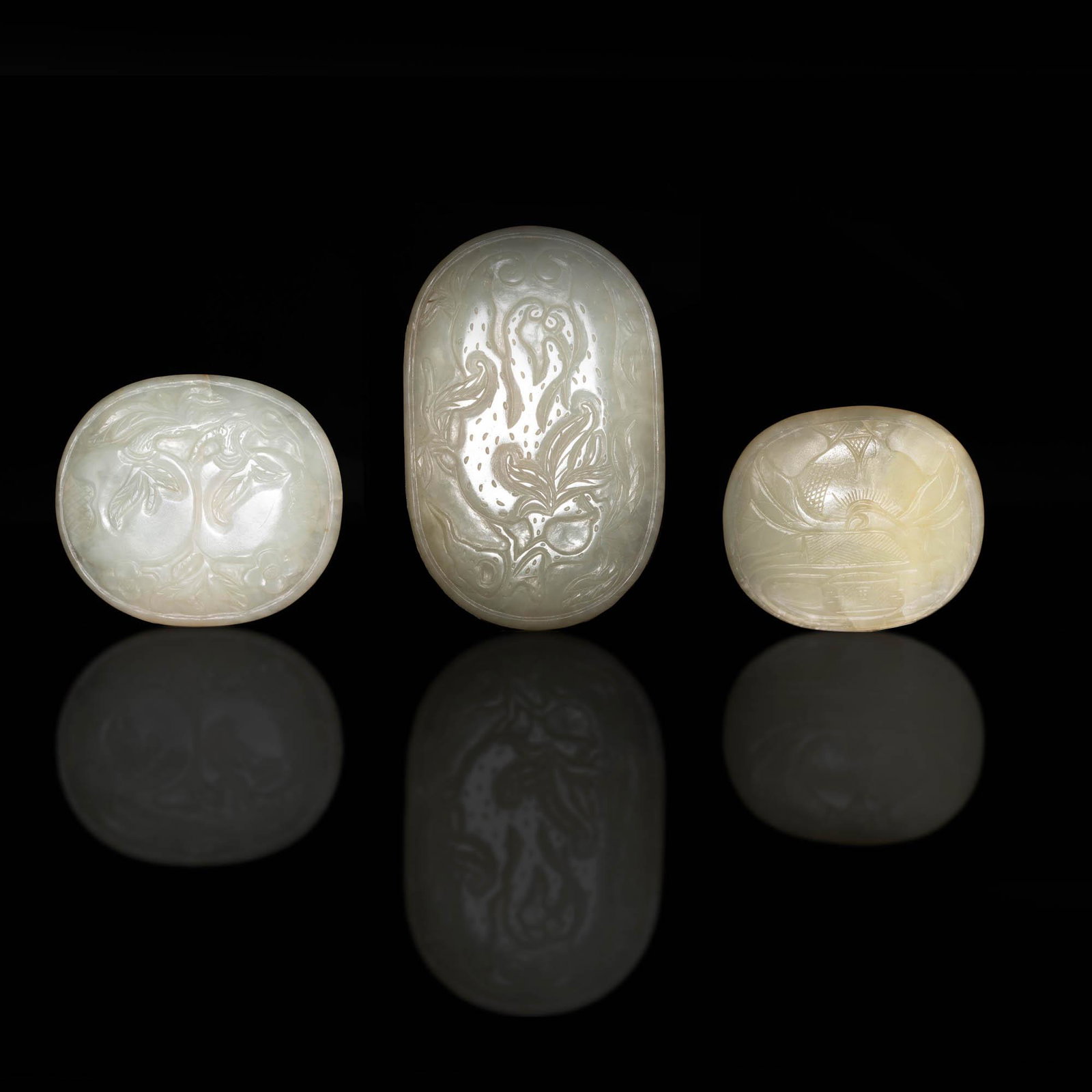 A collection of three Chinese jade plaques, 19th century: A collection of three Chinese jade plaques 19th century The versos with previous collector seals. (3). H: 4 1/8, W: 2 5/8, D: 3/8 in. H: 10.48, W: 6.67 D: 0.95 cm. (lgst) Provenance: Collection of Mr.