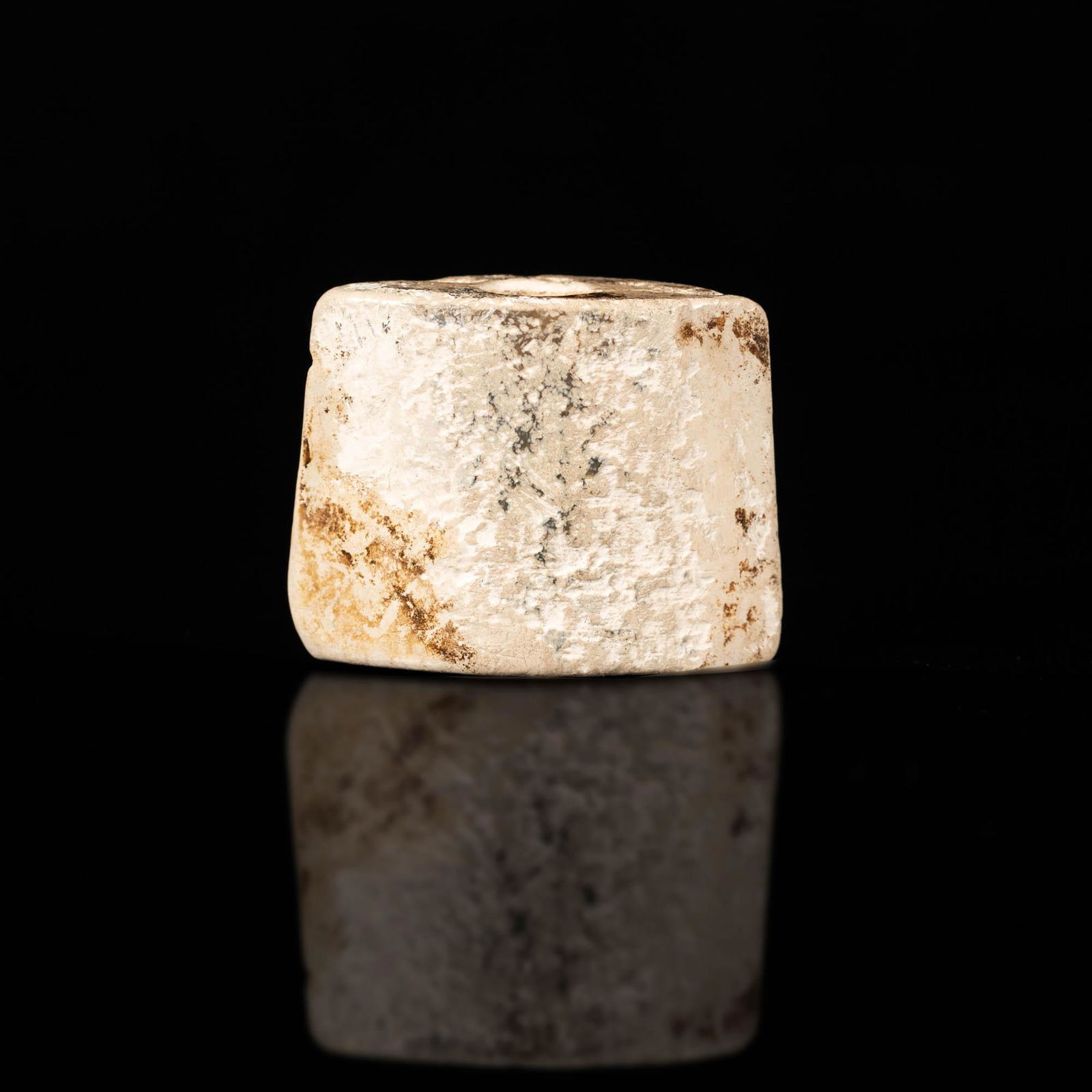 A Chinese jade sword pommel, Warring States period: A Chinese jade sword pommel Warring States period With previous collector sticker to underside. H: 1 1/4, W: 1 3/4, D: 3/4 in. H: 3.2, W: 4.4, D: 1.9 cm. Provenance: Mr. Lee, Houston, Texas. Items wer