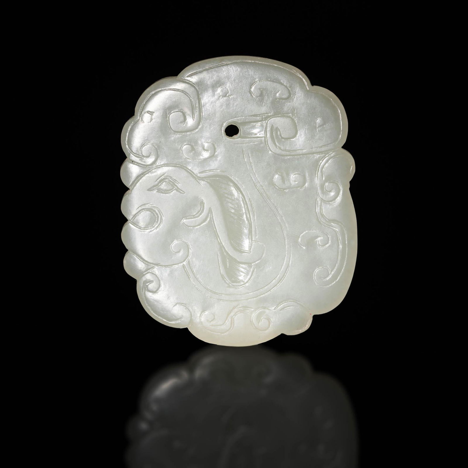 A Chinese carved white jade dragon plaque, 18th century (1 of 3)