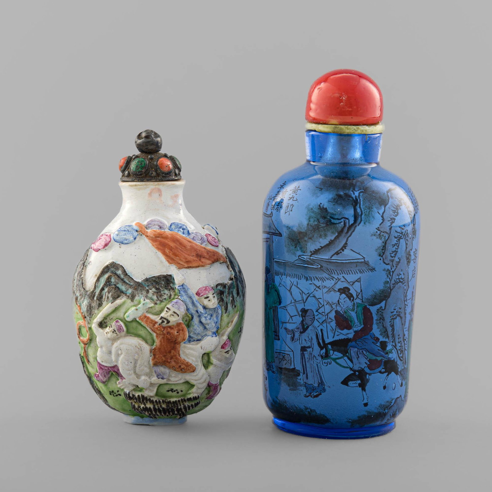 Two Chinese snuff bottles with figures, 19th century: Two Chinese snuff bottles with figures 19th century Comprising one of carved famille rose porcelain with numerous figures and an elephant in an outdoor setting, with two-character mark to underside; a