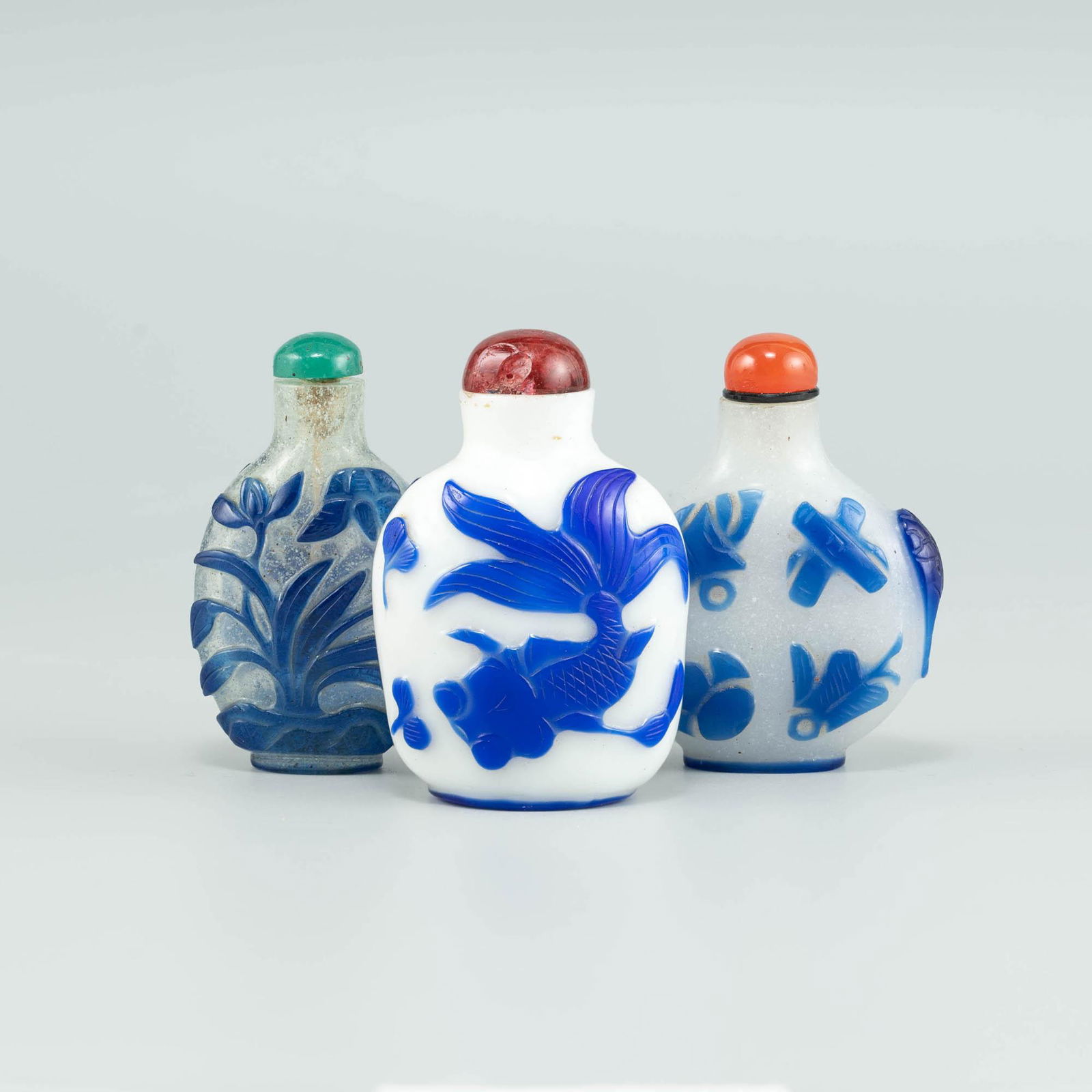 Three Chinese blue-overlay white glass snuff bottles, 19th century (1 of 8)