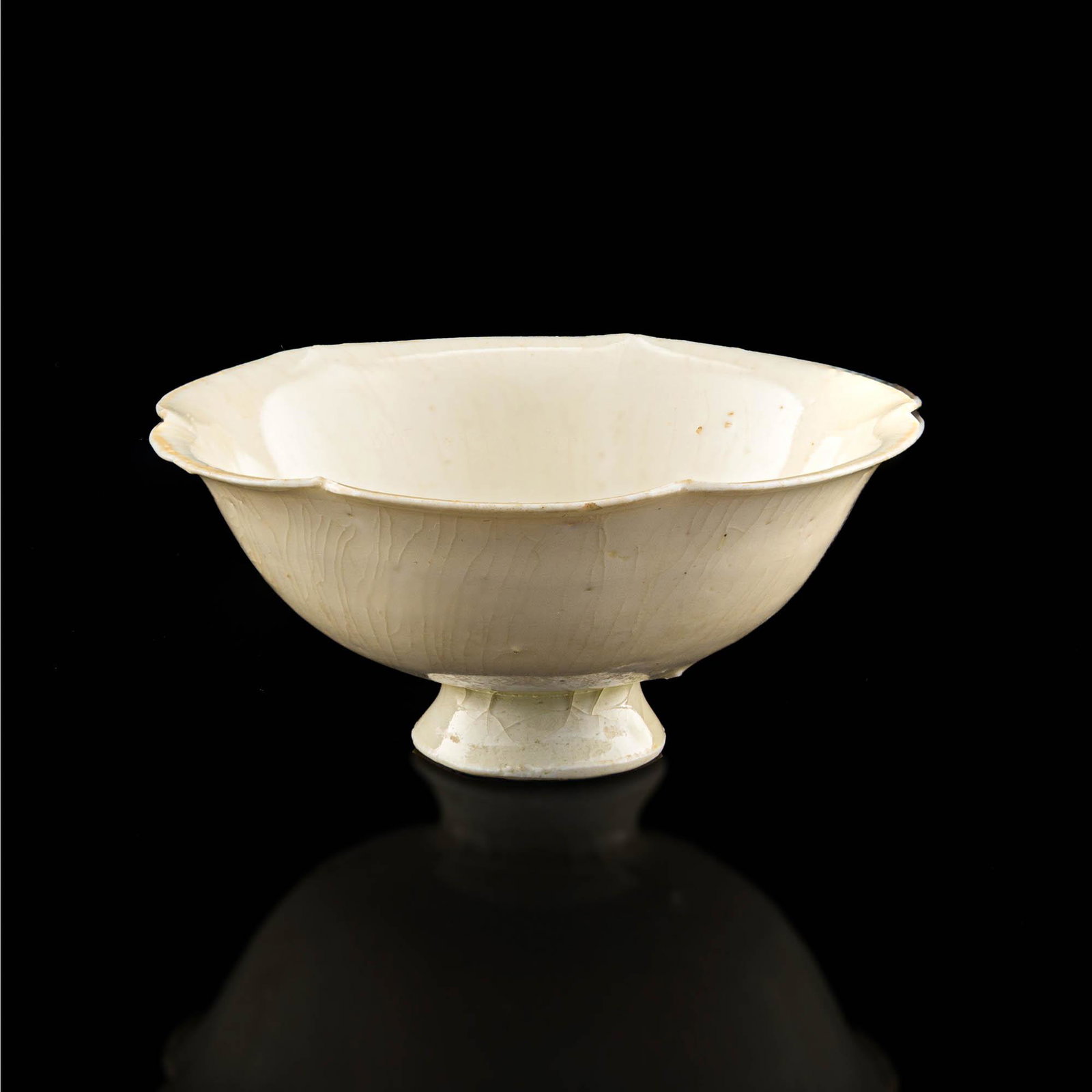 A Chinese white-glazed lotus-form bowl, Song dynasty: A Chinese white-glazed lotus-form bowl Song dynasty H: 1 7/8, Dia: 4 1/8 in. H: 4.76, Dia: 10.48 cm. Provenance: Ms. Chen, Seattle, Washington. Collected by her grandfather in Hong Kong from 1950s to 