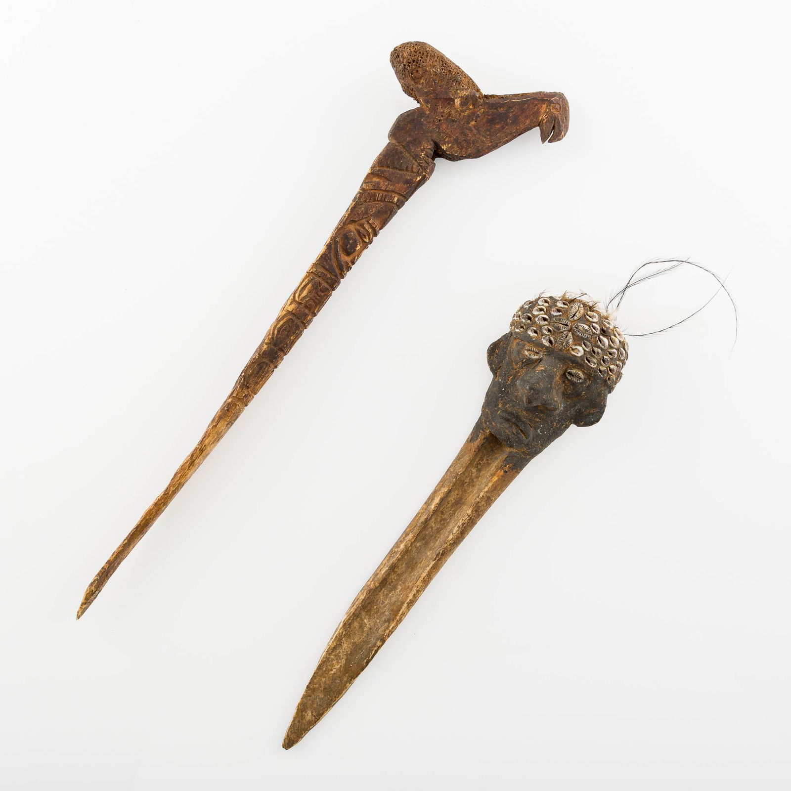 A Papua New Guinean bone 'payback' and bird dagger, late 19th-20th century: A Papua New Guinean bone 'payback' and bird dagger late 19th-20th century Original to the Middle Sepik River. (2). H: 16 1/4, W: 1 3/8, D: 4 in. H: 41.27, W: 3.5, D: 10.16 cm. (largest) Provenance: Es