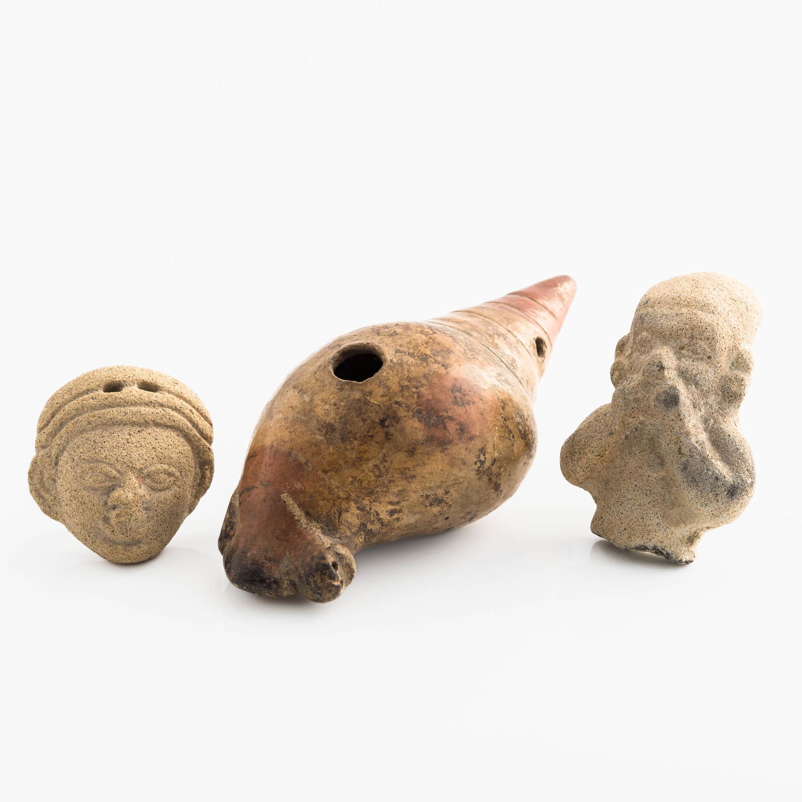 A Sinu shell-form ocarina and two Tumaco fragments, Sinu culture (c. 400-1550 CE) (1 of 6)