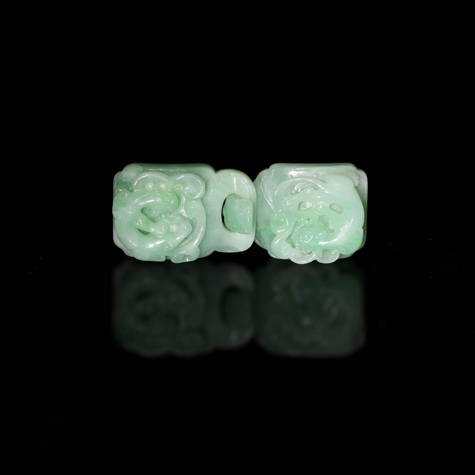 A Chinese jadeite chilong buckle, 19th century: A Chinese jadeite chilong buckle 19th century H: 7/8, W: 2 1/4, D: 1/4 in. H: 2.22, W: 5.71, D: 0.63 cm. (overall) Provenance: Private collection, Massachusetts. C