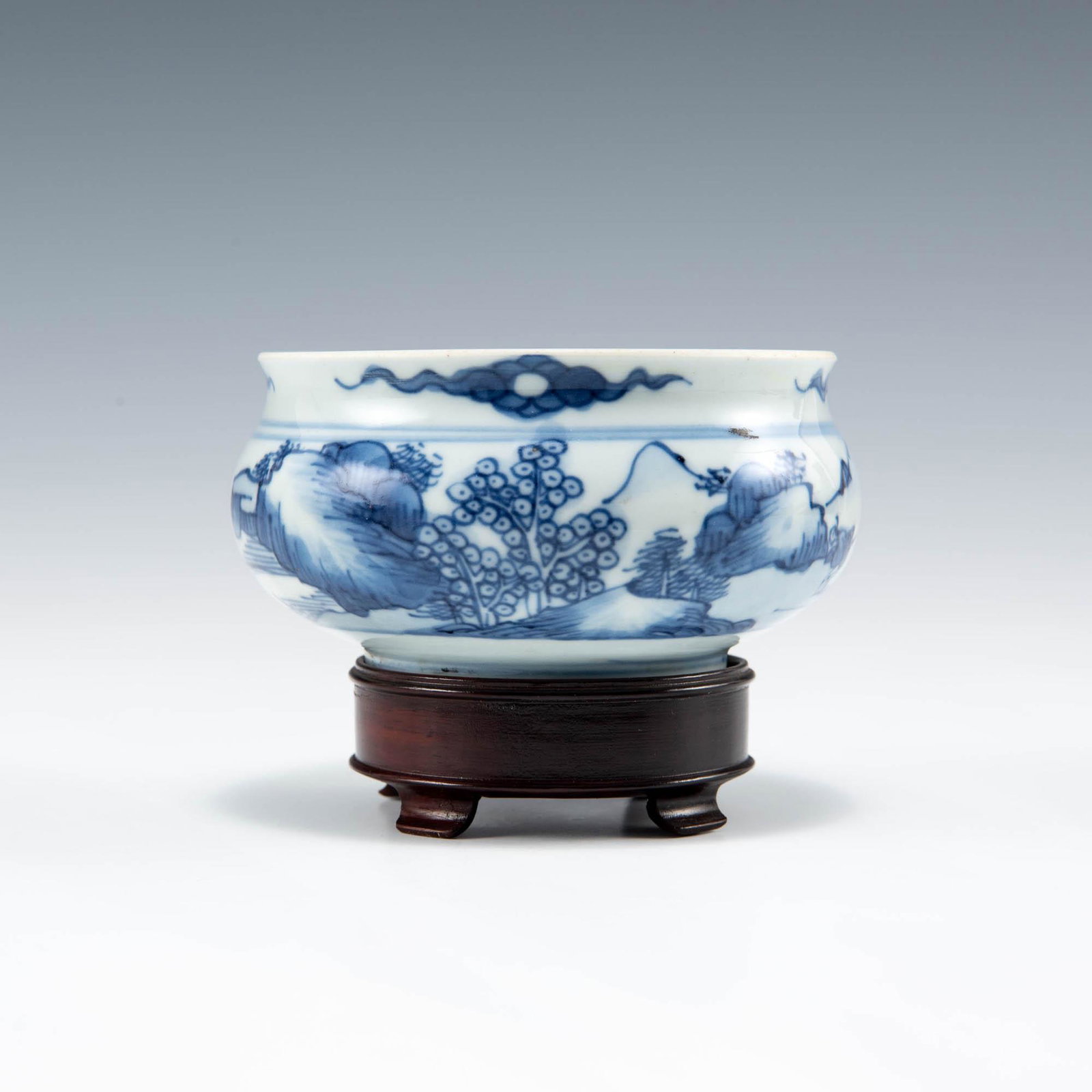 A Chinese blue and white landscape censer, Kangxi period, Qing dynasty: A Chinese blue and white landscape censer Kangxi period, Qing dynasty Sold with associated wooden stand. H: 2 1/4, Dia: 4 1/4 in. H: 5.71, Dia: 10.79 cm. Provenance: Mrs. Chang, Newport Beach, Califor
