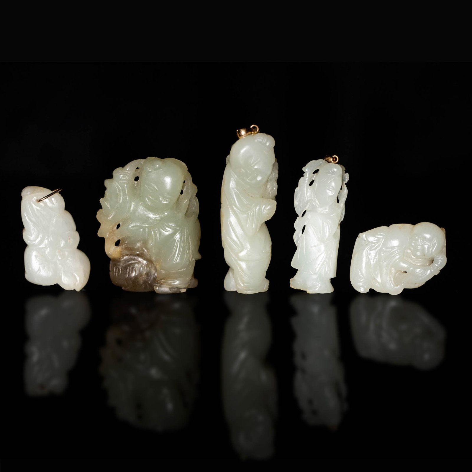 Five Chinese jade carvings, Ming-Qing dynasty: Five Chinese jade carvings Ming-Qing dynasty Comprising a court lady figural toggle; a toggle of a young boy with brown natural inclusions; a young boy figural toggle; a toggle of Lui Hai with three-l