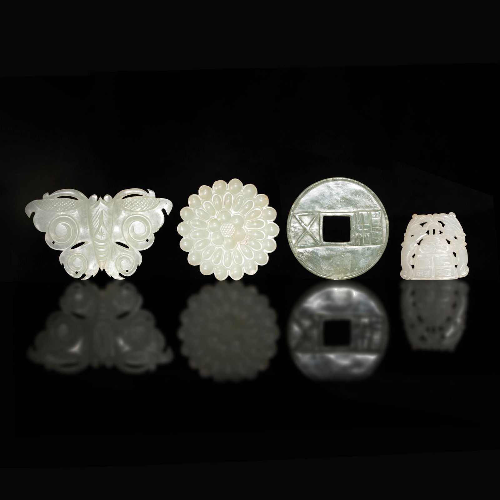 Four Chinese carved jade plaques, Ming and Qing dynasty: Four Chinese carved jade plaques Ming and Qing dynasty Comprising a plaque featuring a bell with flanking chilong; a flower-form plaque; a coin shaped plaque; and a butterfly shaped plaque. (4). H: 2,