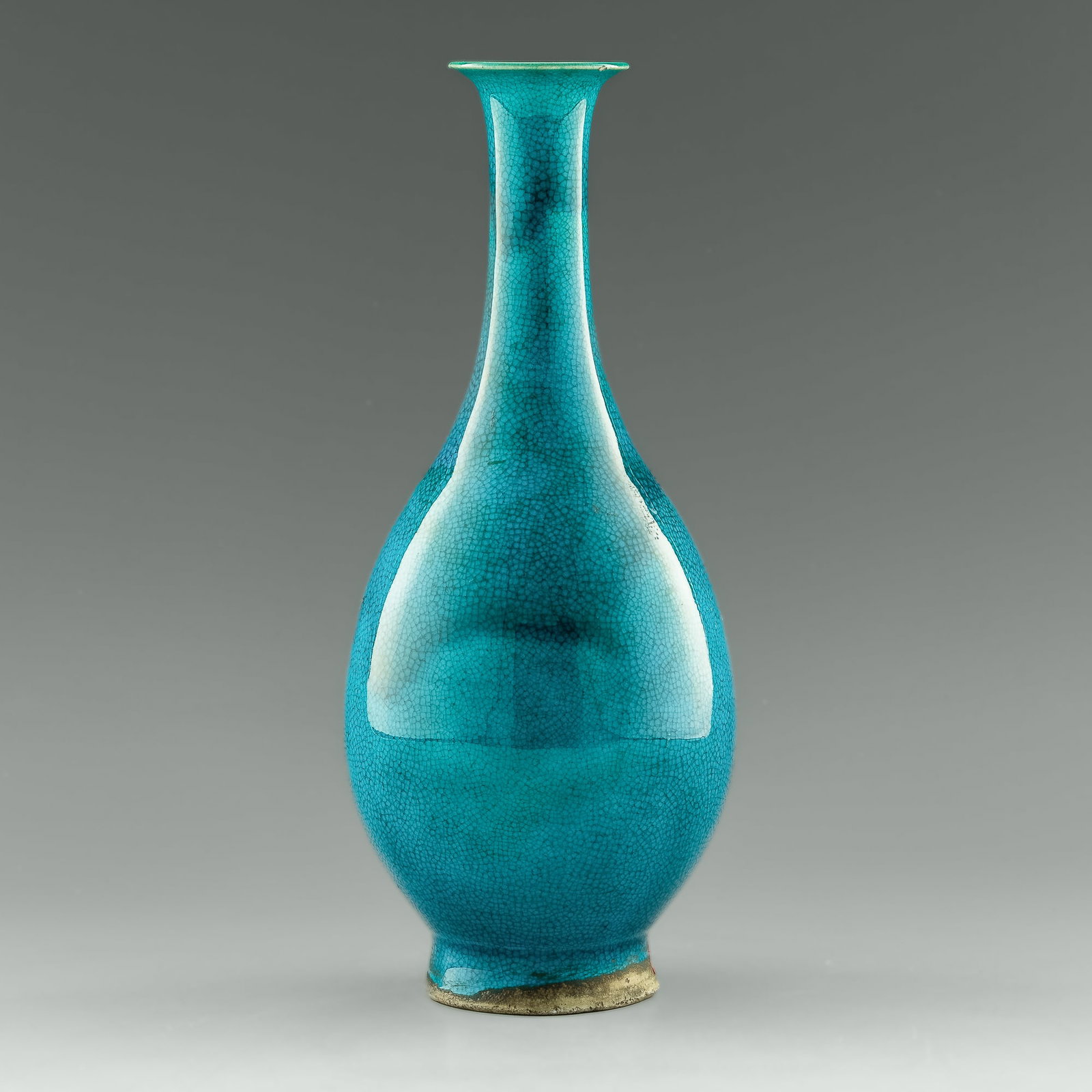 A Chinese turquoise-glaze long neck vase, Ming dynasty: A Chinese turquoise-glaze long neck vase Ming dynasty Featuring swirls of darker blue glaze throughout. With previous collector's sticker to underside and previous collector's tag to neck. H: 9 5/8, D