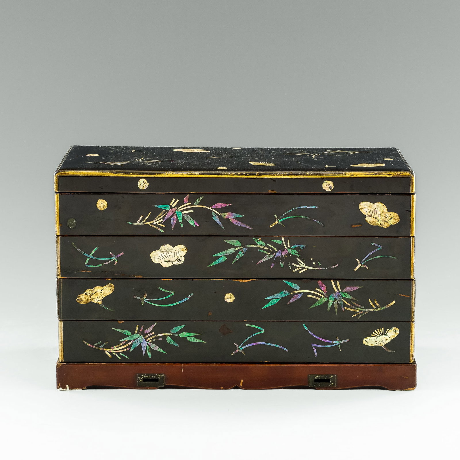 A Chinese lacquered stationary box with mother-of-pearl inlay, 18th century: A Chinese lacquered stationary box with mother-of-pearl inlay 18th century The lidded box comprising four stacked tiers; each with red-lacquered interior and an inkstone, three tiers with a metal wate