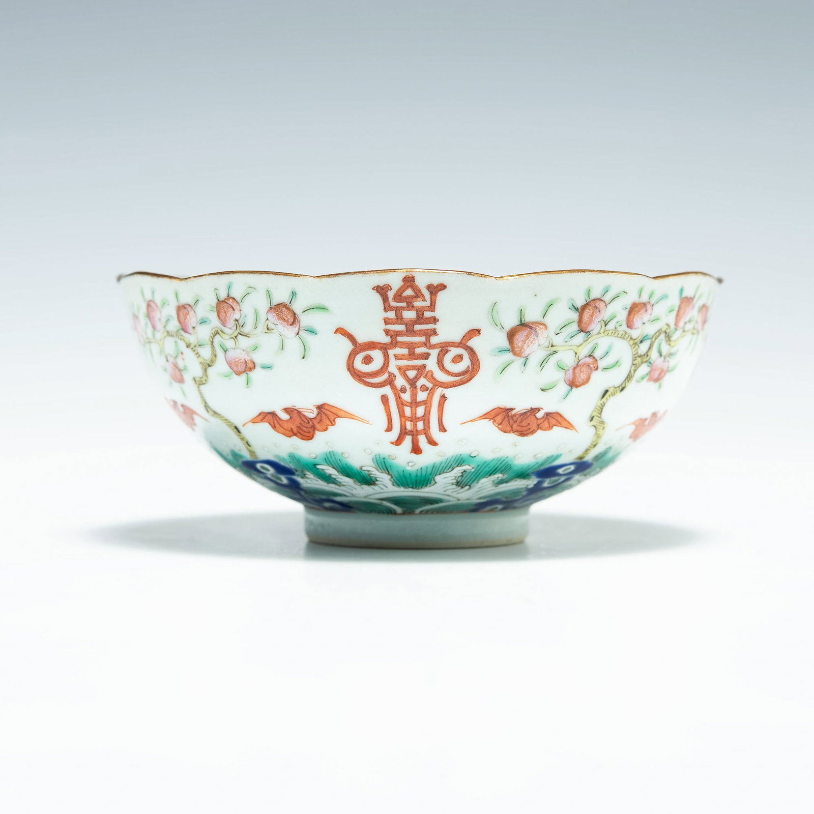 A Chinese famille rose bowl, Jiaqing period, Qing Dynasty: A Chinese famille rose bowl Jiaqing period, Qing Dynasty Featuring a bat with peaches to interior and bat among peach trees and stylized shou characters to exterior. With six-character mark to undersi