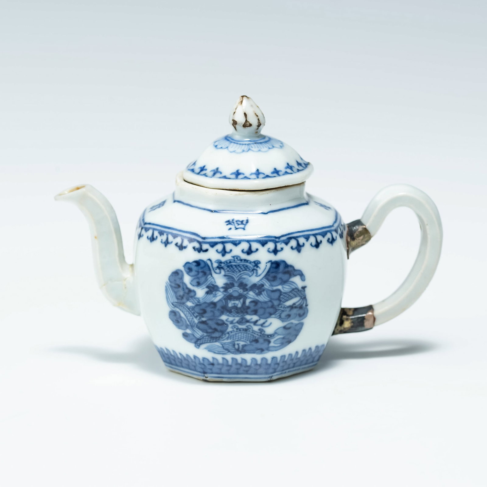 A Vietnamese blue and white teapot, Thieu Tri period: A Vietnamese blue and white teapot Thieu Tri period Featuring dragon roundels to either side of exterior with characters encircling shoulder. The slender spout and handle both faceted. H: 3, W: 4 3/8,