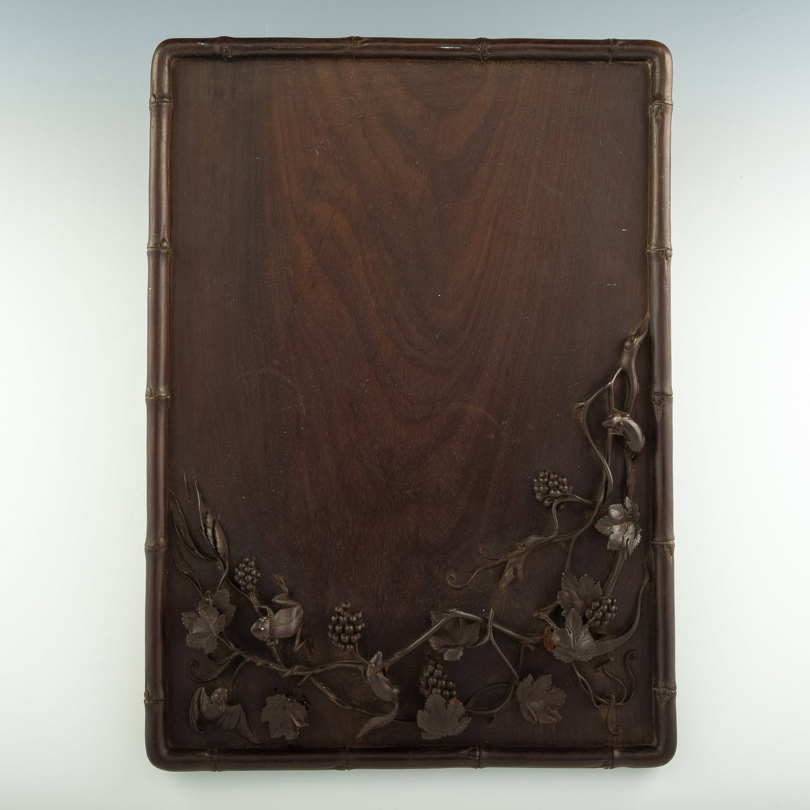A Chinese carved hardwood 'animal' and 'grape' tea tray, Republic period: A Chinese carved hardwood 'animal' and 'grape' tea tray Republic period H: 14 1/8, W: 19 5/8, D: 3/4 in. H: 35.88, W: 49.85, D: 1.91 cm. Provenance: Private collection, New York.