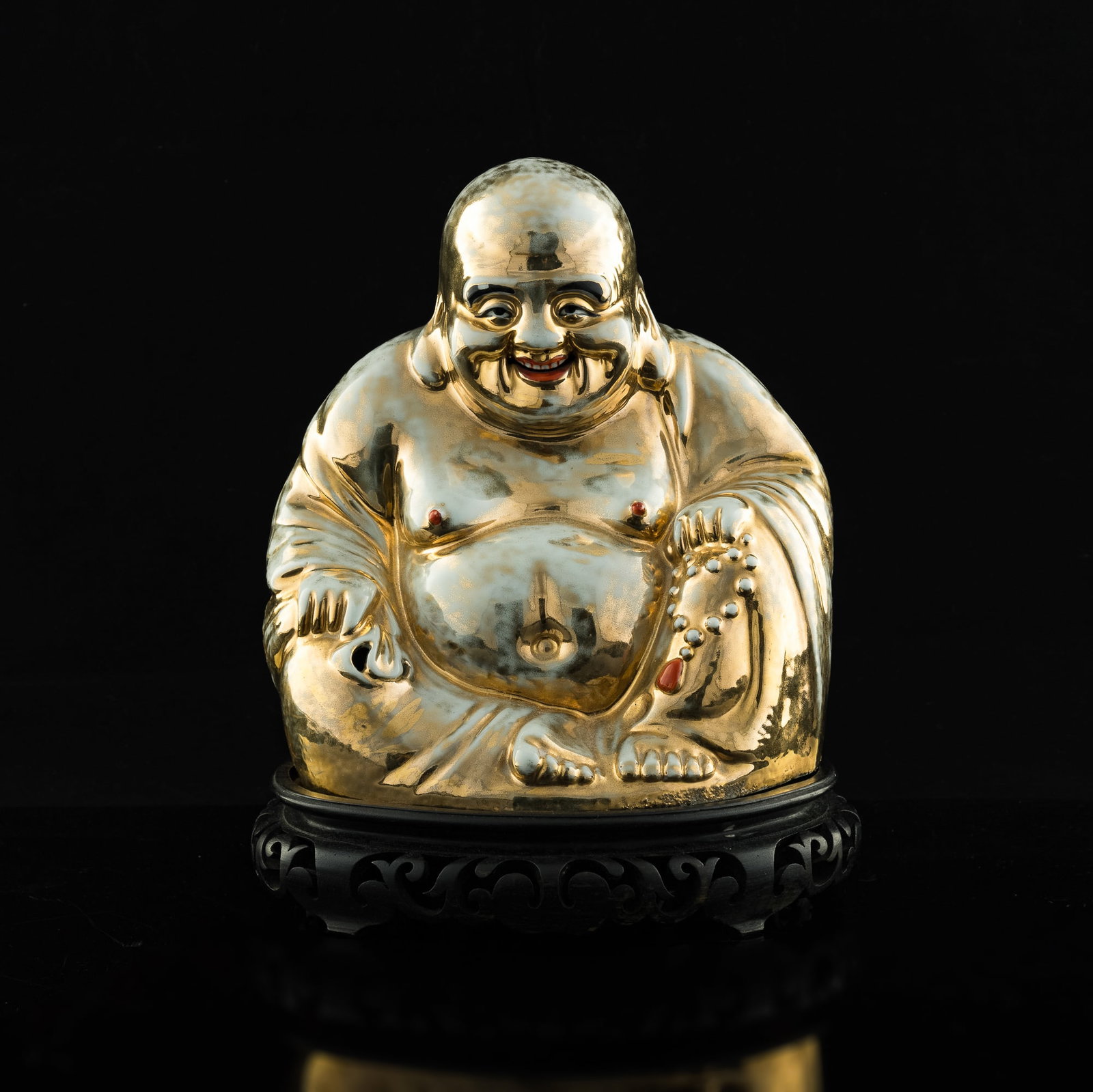 A Chinese gilt-enameled porcelain Buddha statue, Republic period: A Chinese gilt-enameled porcelain Buddha statue Republic period Sold with associated wooden stand. H: 9 5/8, W: 8 3/4, D: 6 in. (statue) H: 24.45, W: 22.23, D: 15.24 cm. Provenance: Estate of Mr. & Mr