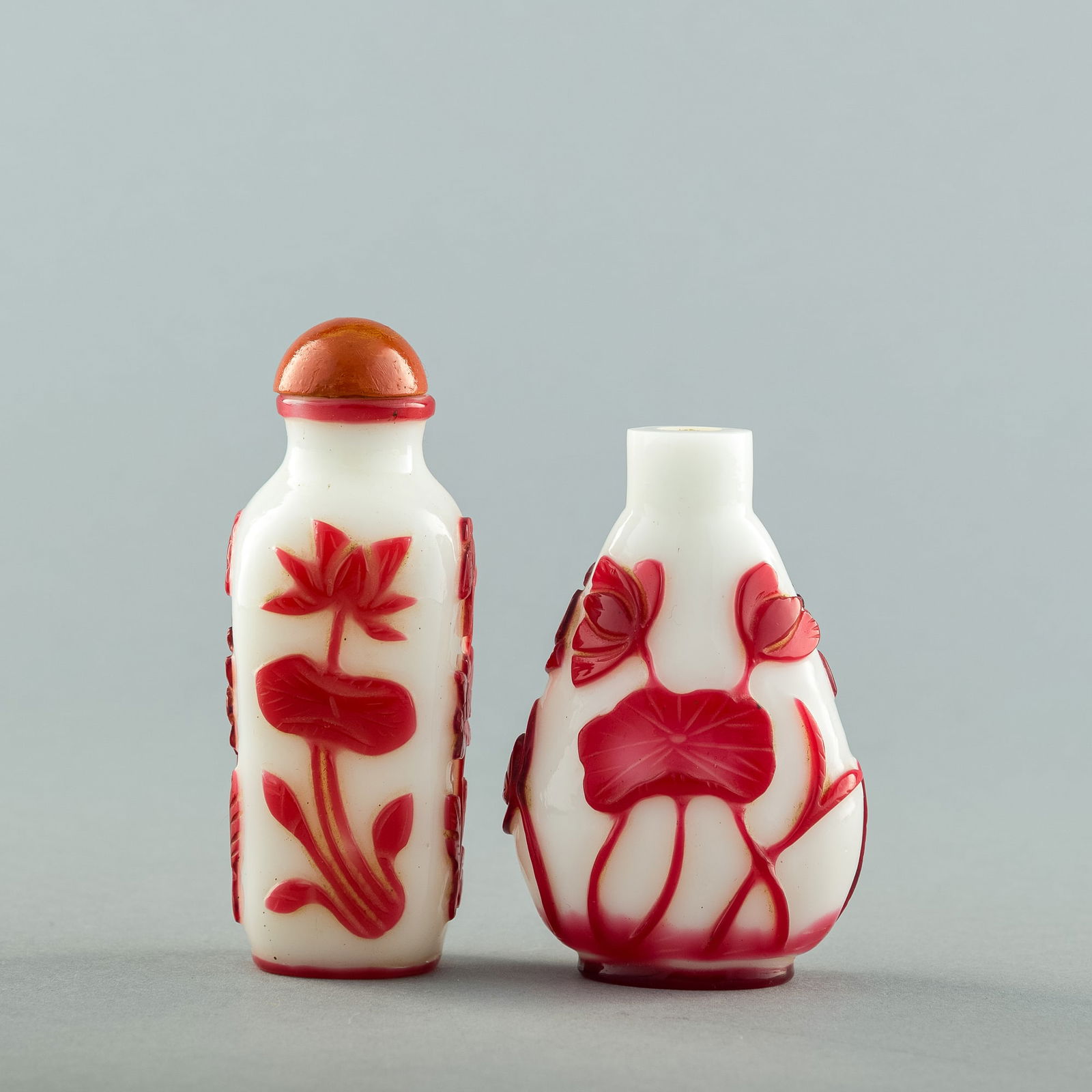 Two Chinese Peking red-overlay white-ground glass snuff bottles, 19th century (1 of 7)