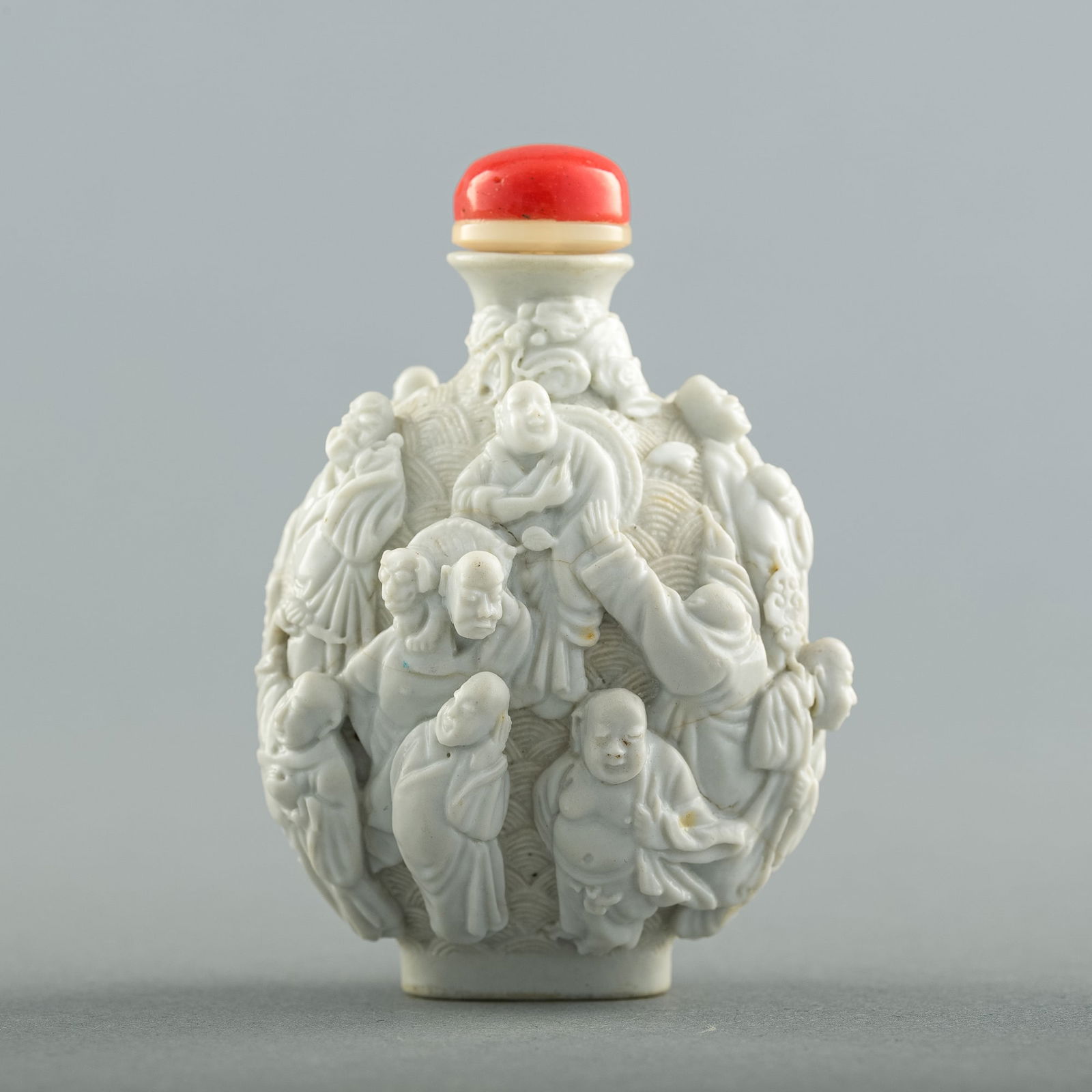 A Chinese carved white-ground 'Luohan' snuff bottle, early 19th century (1 of 6)