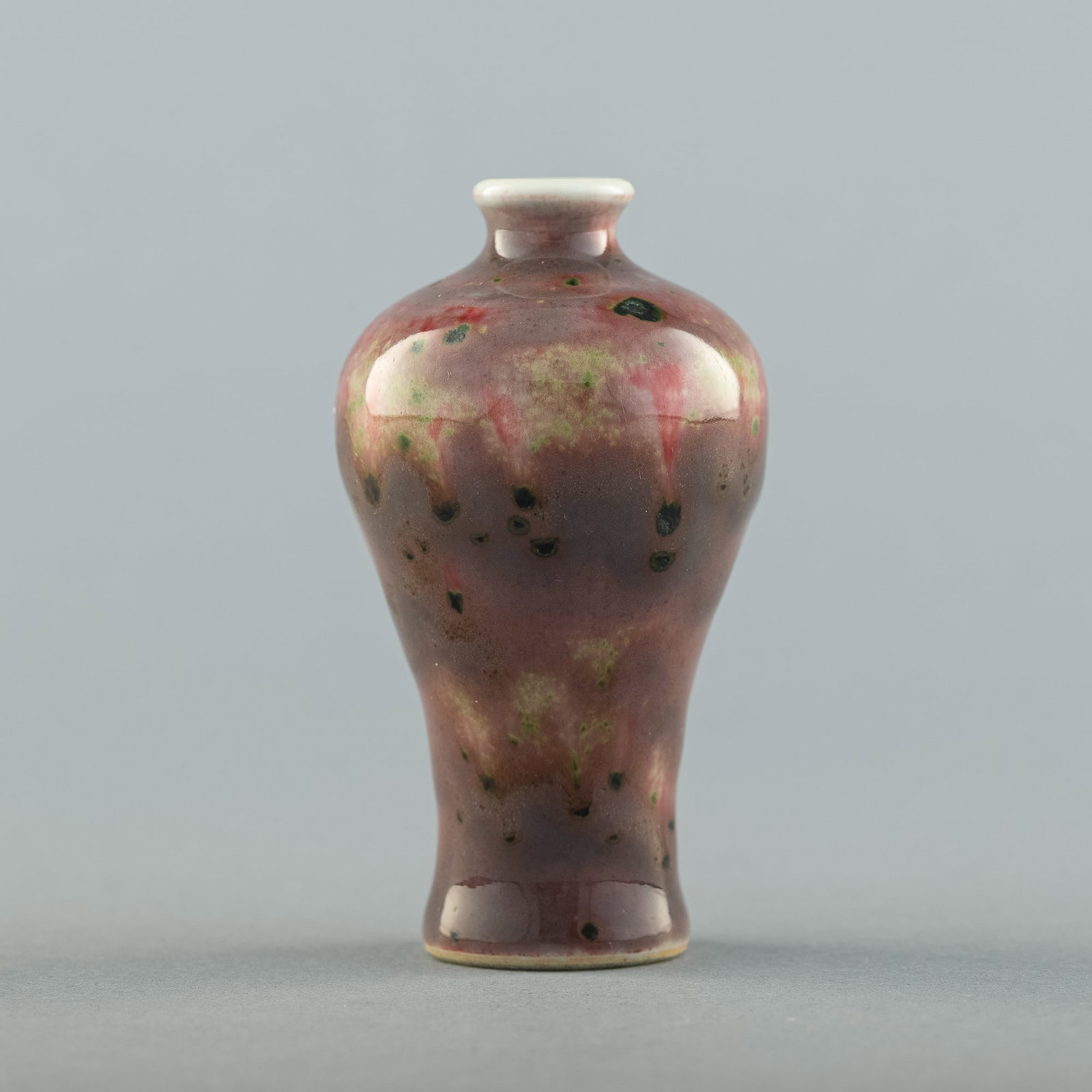 A Chinese peachbloom-glazed meiping snuff bottle, 19th century: A Chinese peachbloom-glazed meiping snuff bottle 19th century With six-character mark to underside. H: 3 1/4, Dia: 1 3/4 in. H: 8.26, Dia: 4.45 cm. Private collection, Florida.