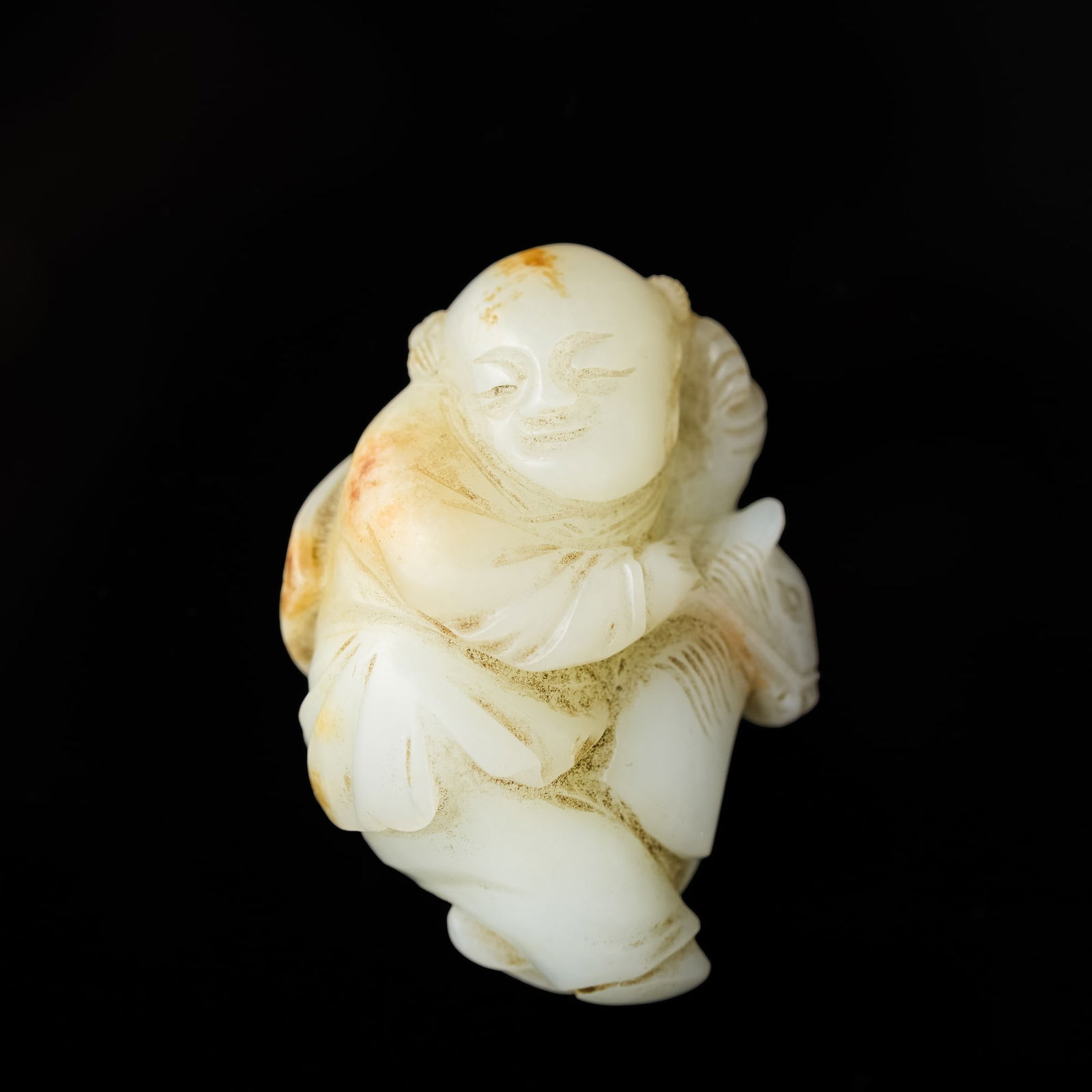 A Chinese carved white jade 'boy riding horse' figure, 18th century or earlier (1 of 6)